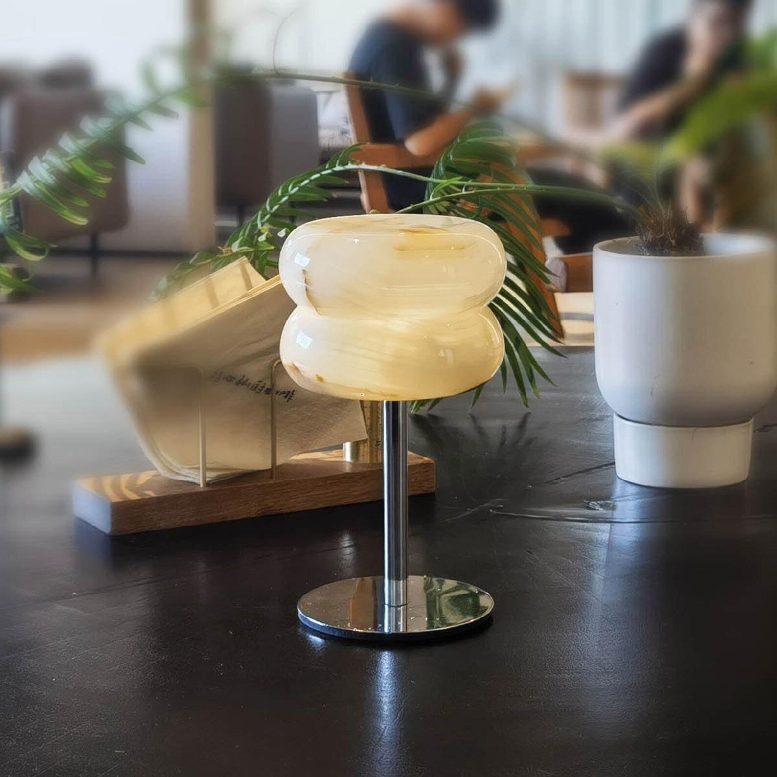 Alabaster Donut Table Lamp illuminated, casting a warm, soft glow.