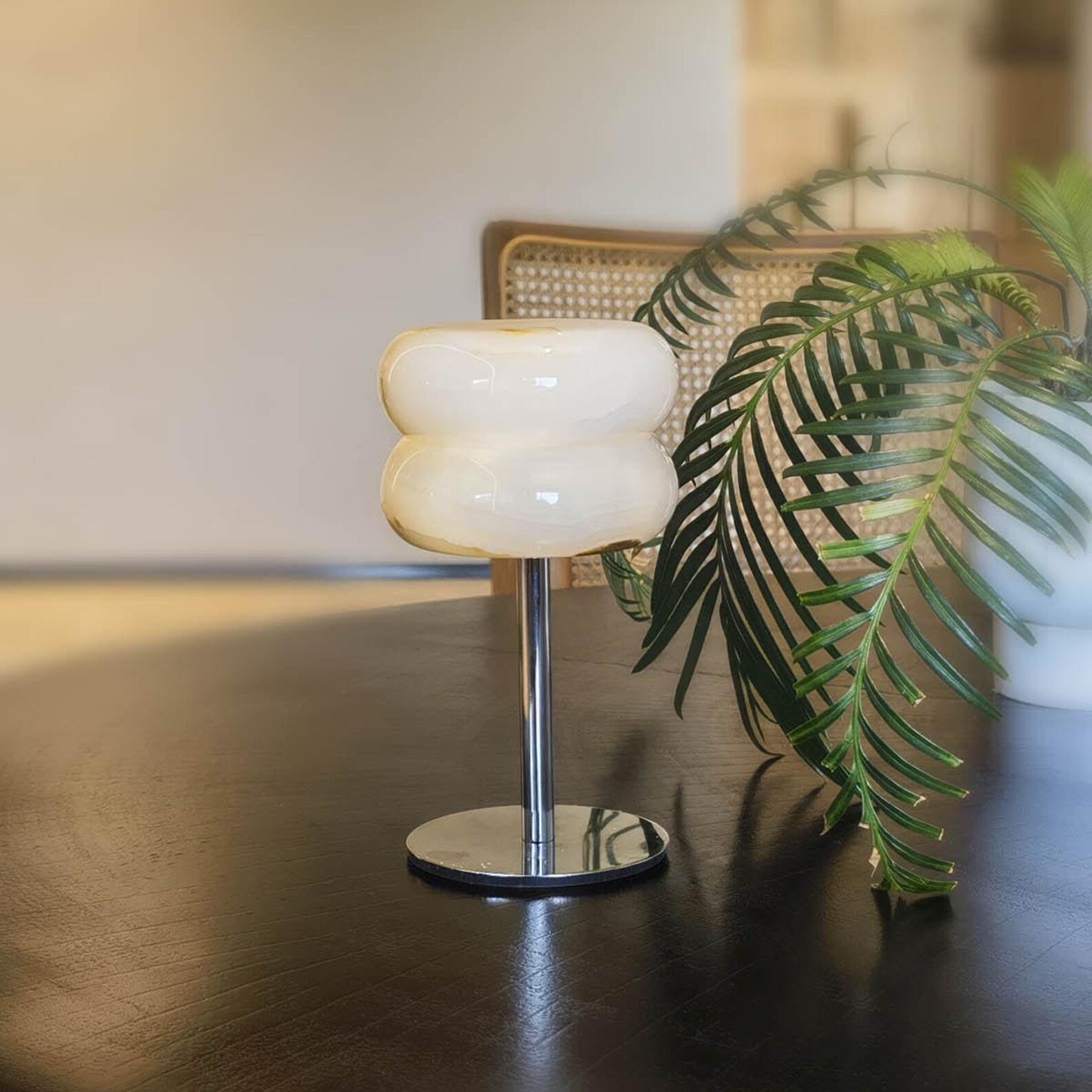 The lamp placed on a bedside table in a modern bedroom setting.