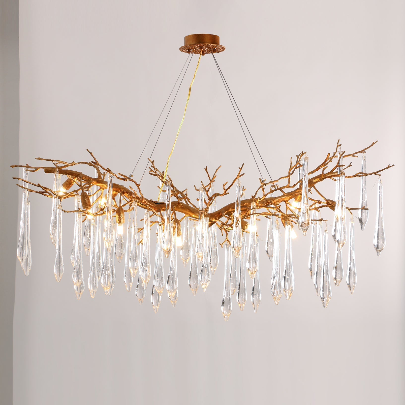 Close-up of the Janae Chandelier's glass shades and brass structure.
