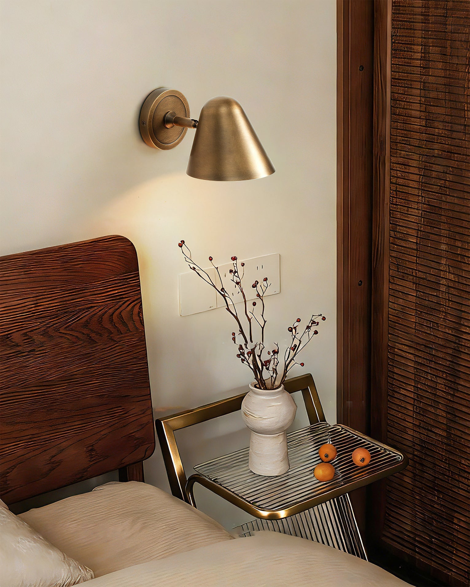 Janna Wall Lamp illuminated, casting a warm downward light.
