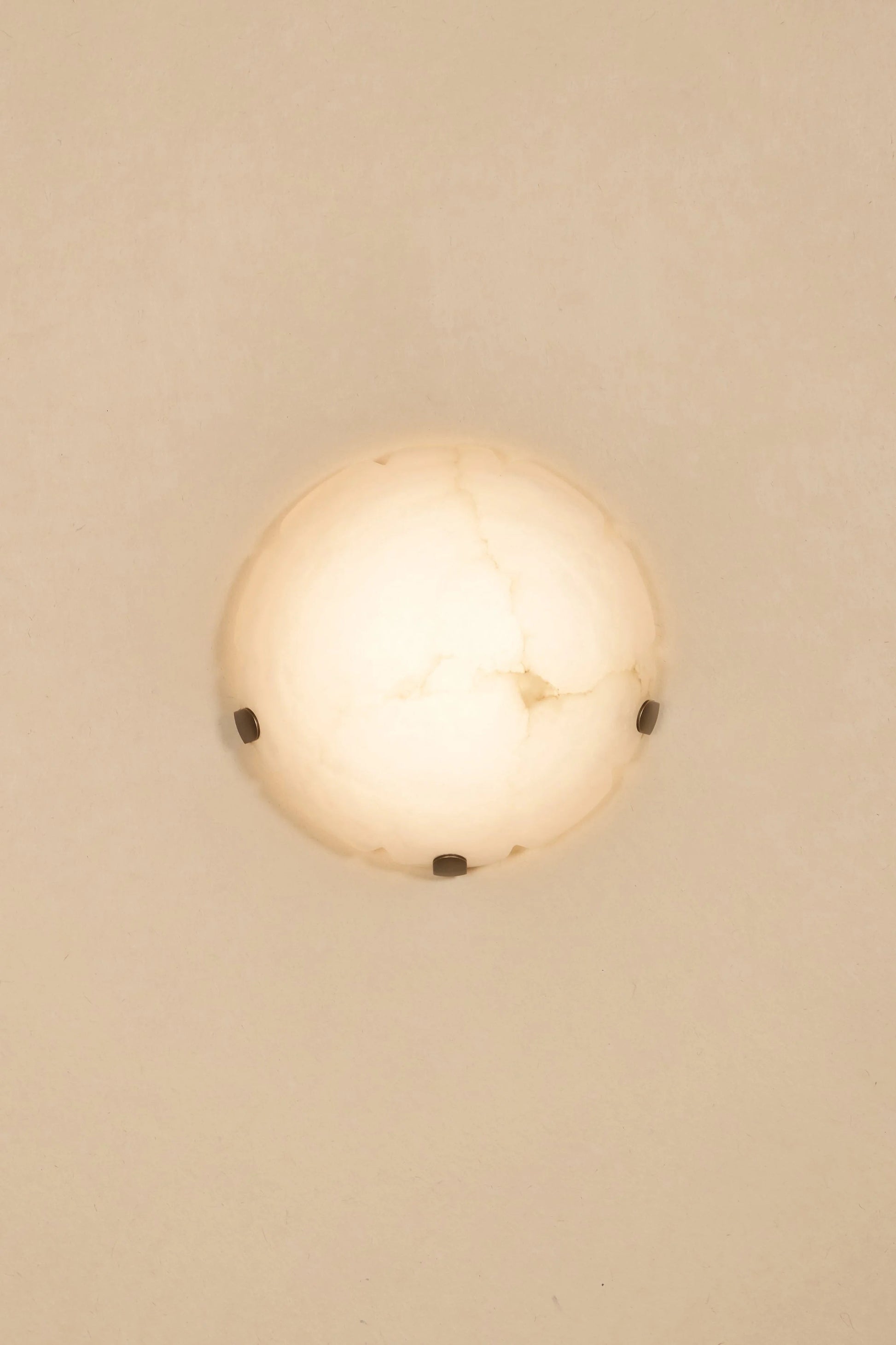 Angled view of the alabaster lamp, highlighting its sculptural form.