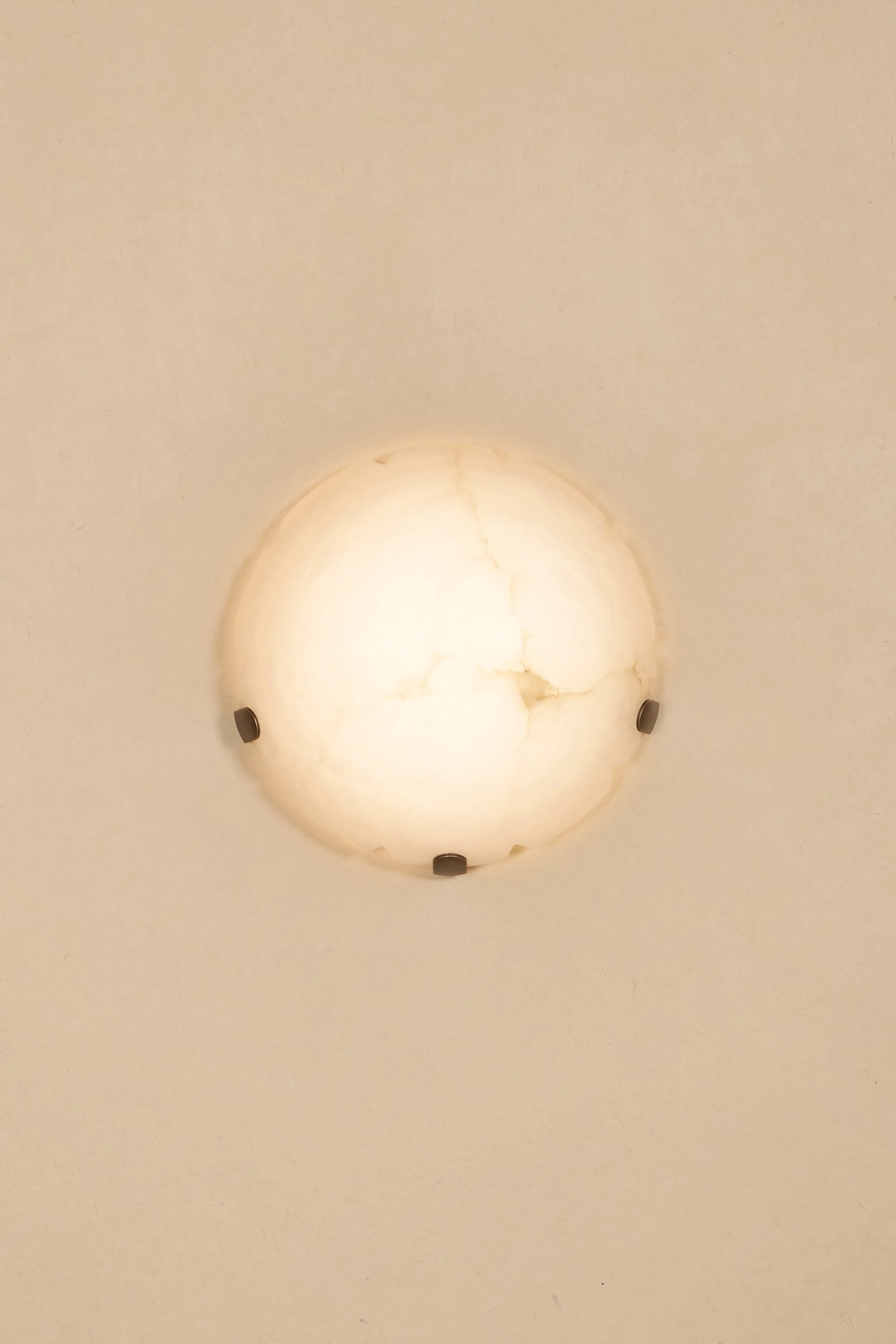 Angled view of the alabaster lamp, highlighting its sculptural form.