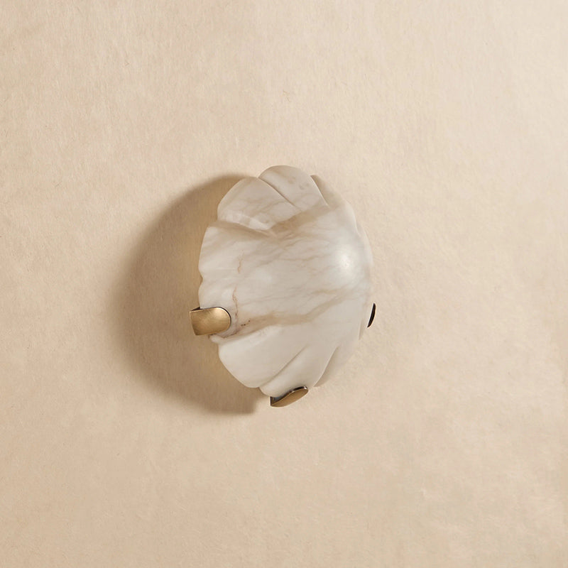 Jellyfish Alabaster Wall Lamp in bronze finish against a dark textured wall.