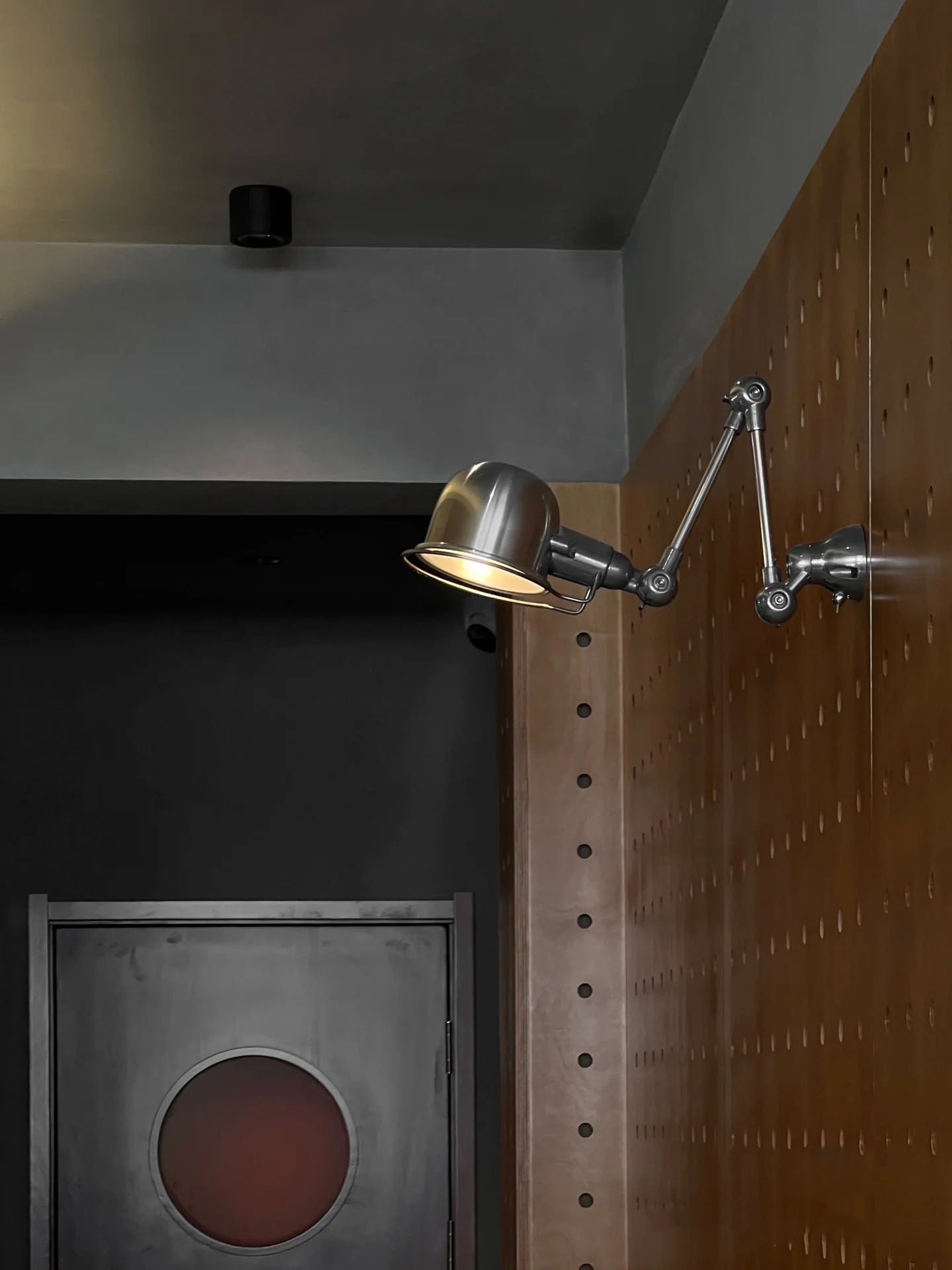 Jielde wall lamp illuminating a desk in an office.