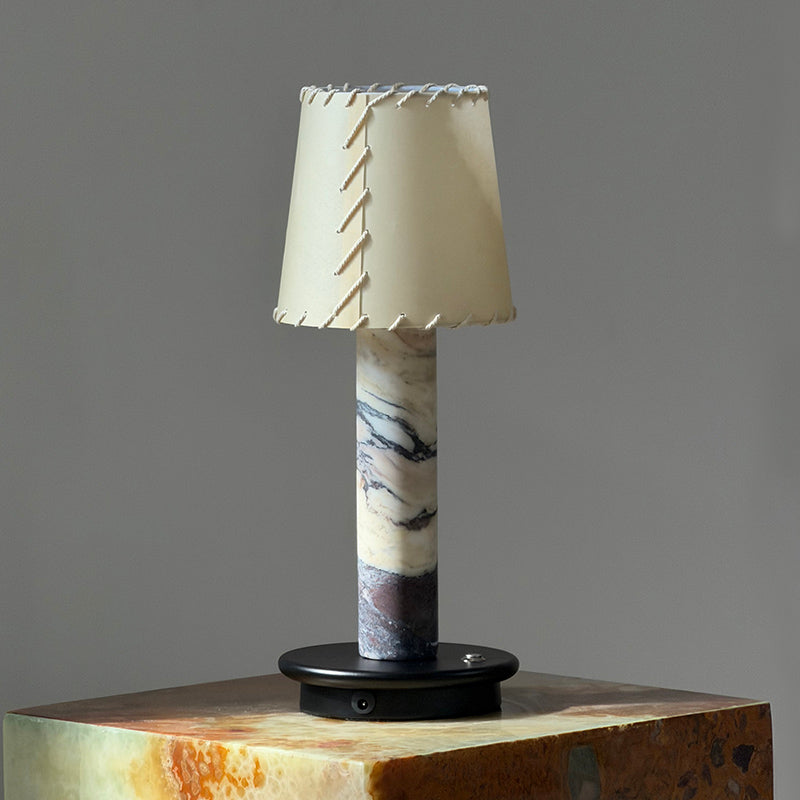 The black Jorgen Table Lamp against a dark background.