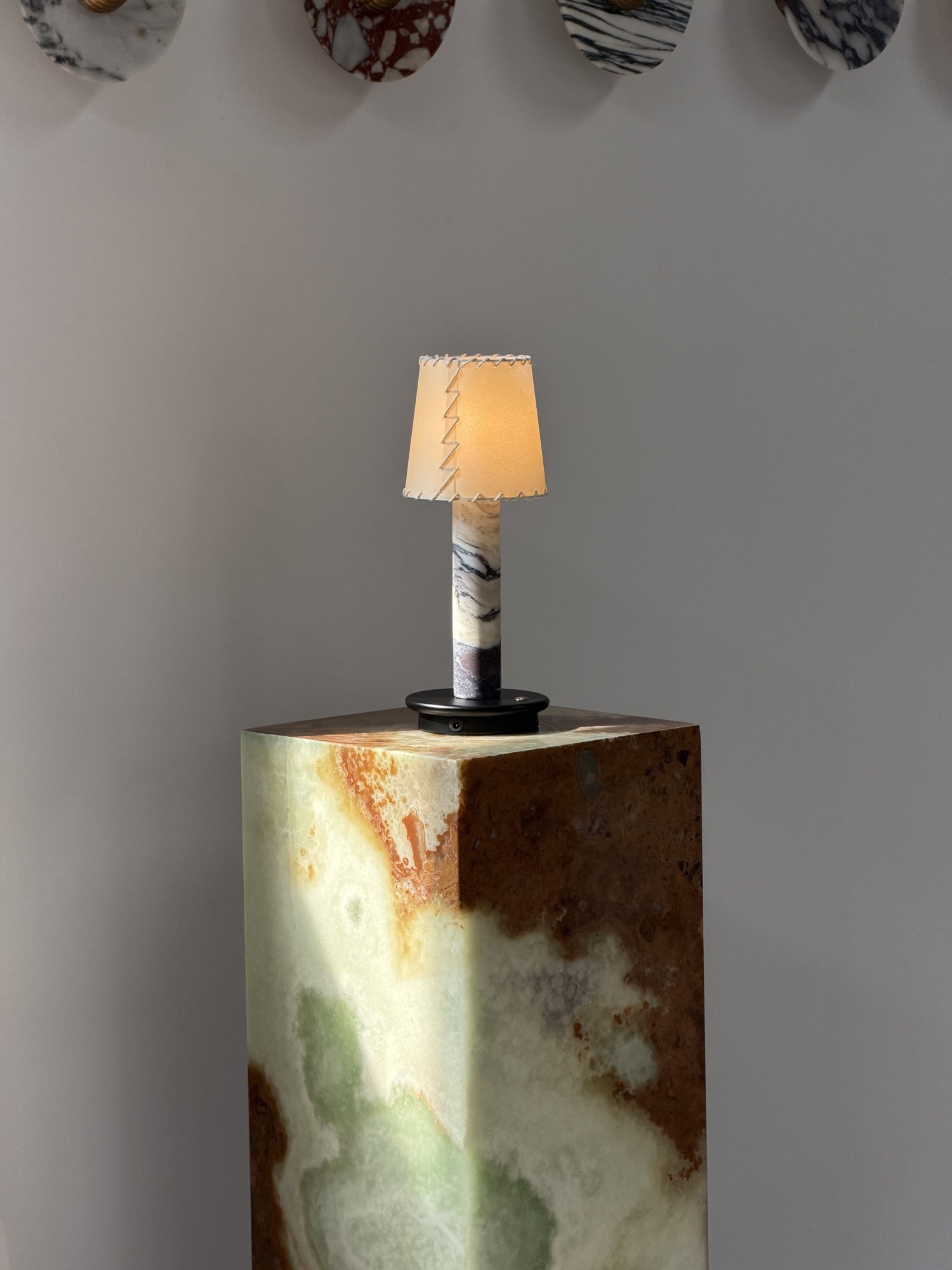 The portable Jorgen Table Lamp placed on a bookshelf.