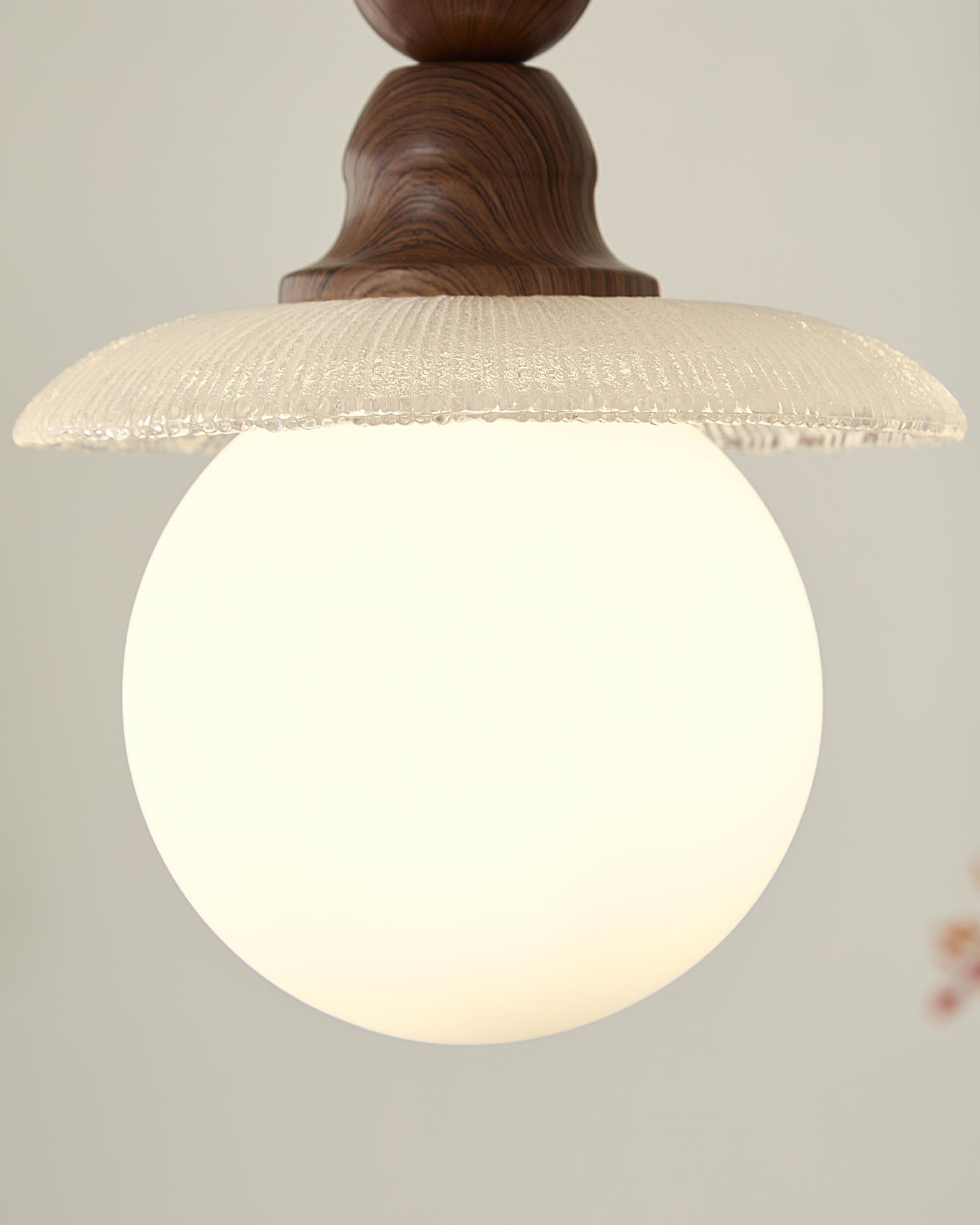 The clean light diffused through the white ribbed glass shade.