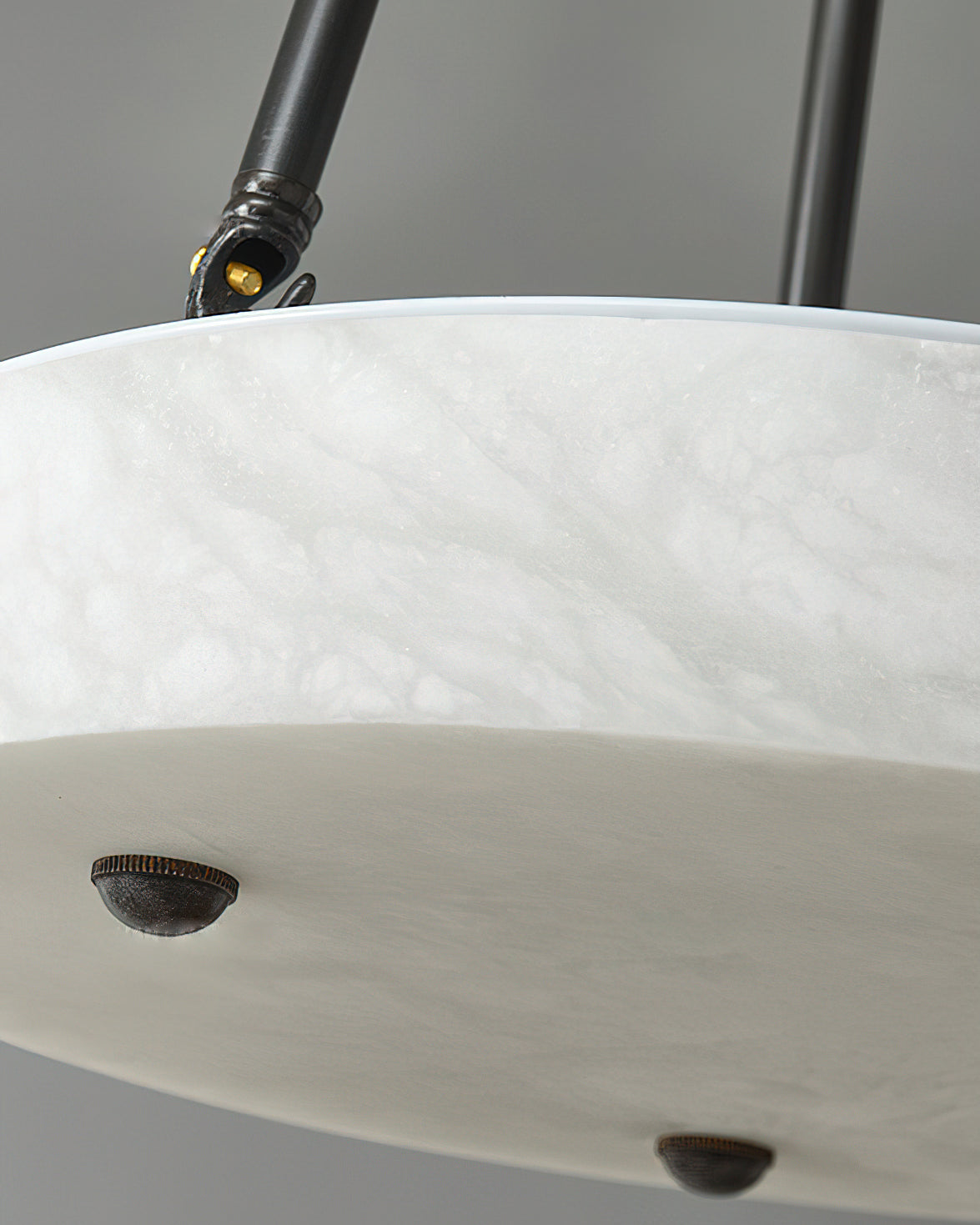 Kayme Alabaster Pendant Lamp against a dark background to emphasize its form.