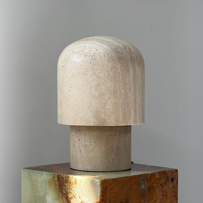 Close-up of the junction between the travertine base and the light element.