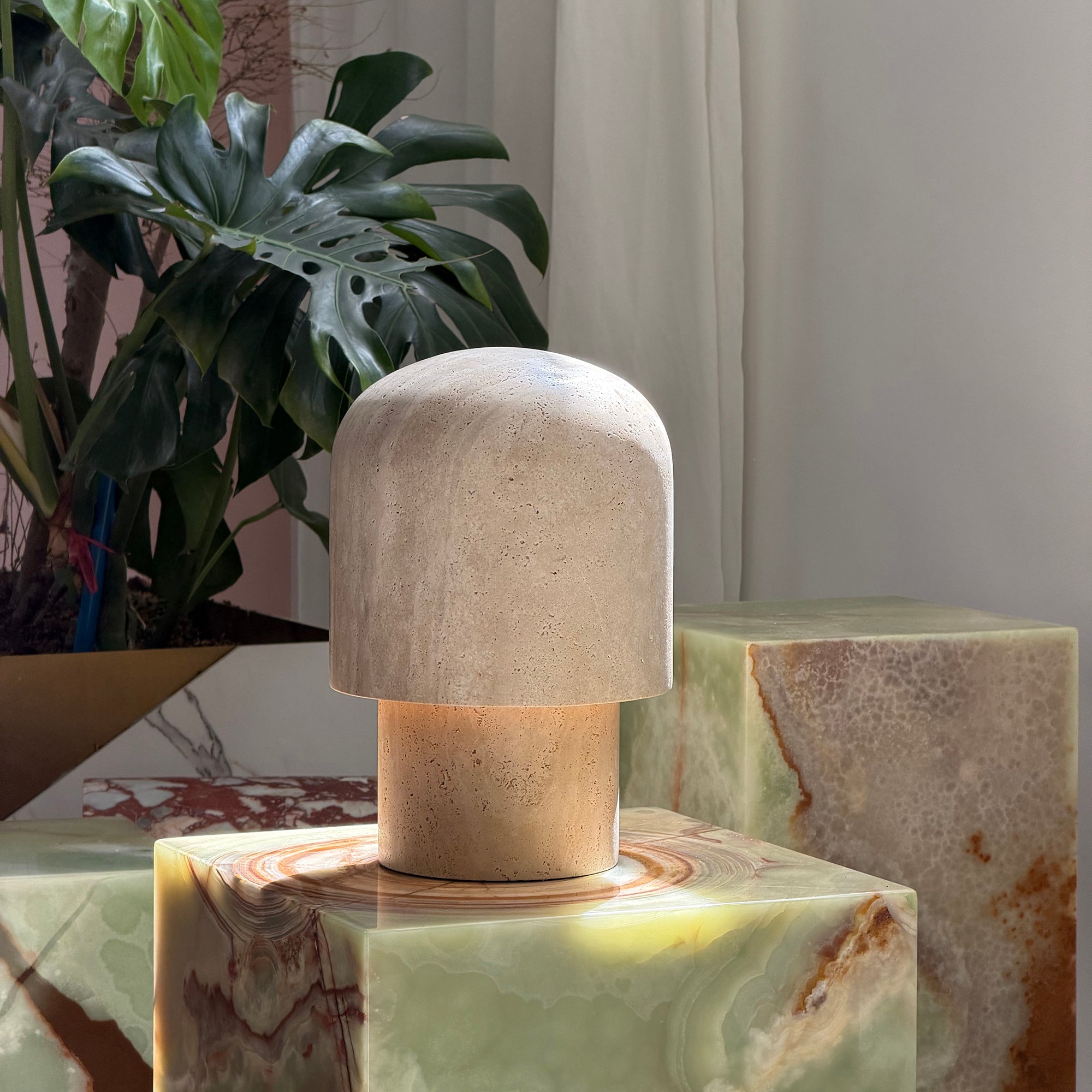 Close-up view of the natural travertine stone texture of the Kennett lamp.
