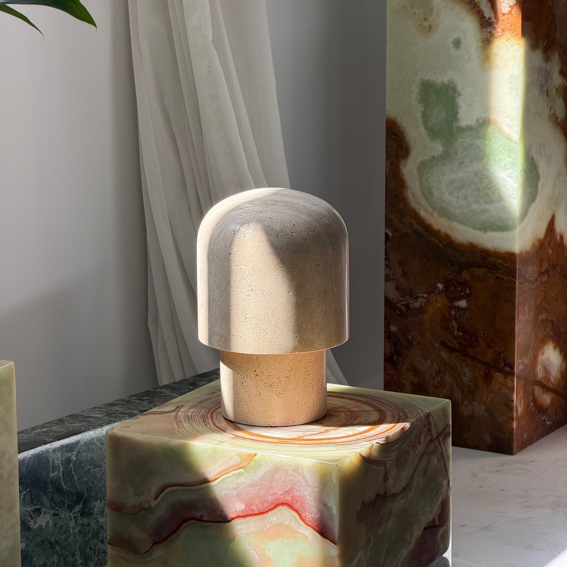 Kennett Travertine Table Lamp styled on a living room side table.