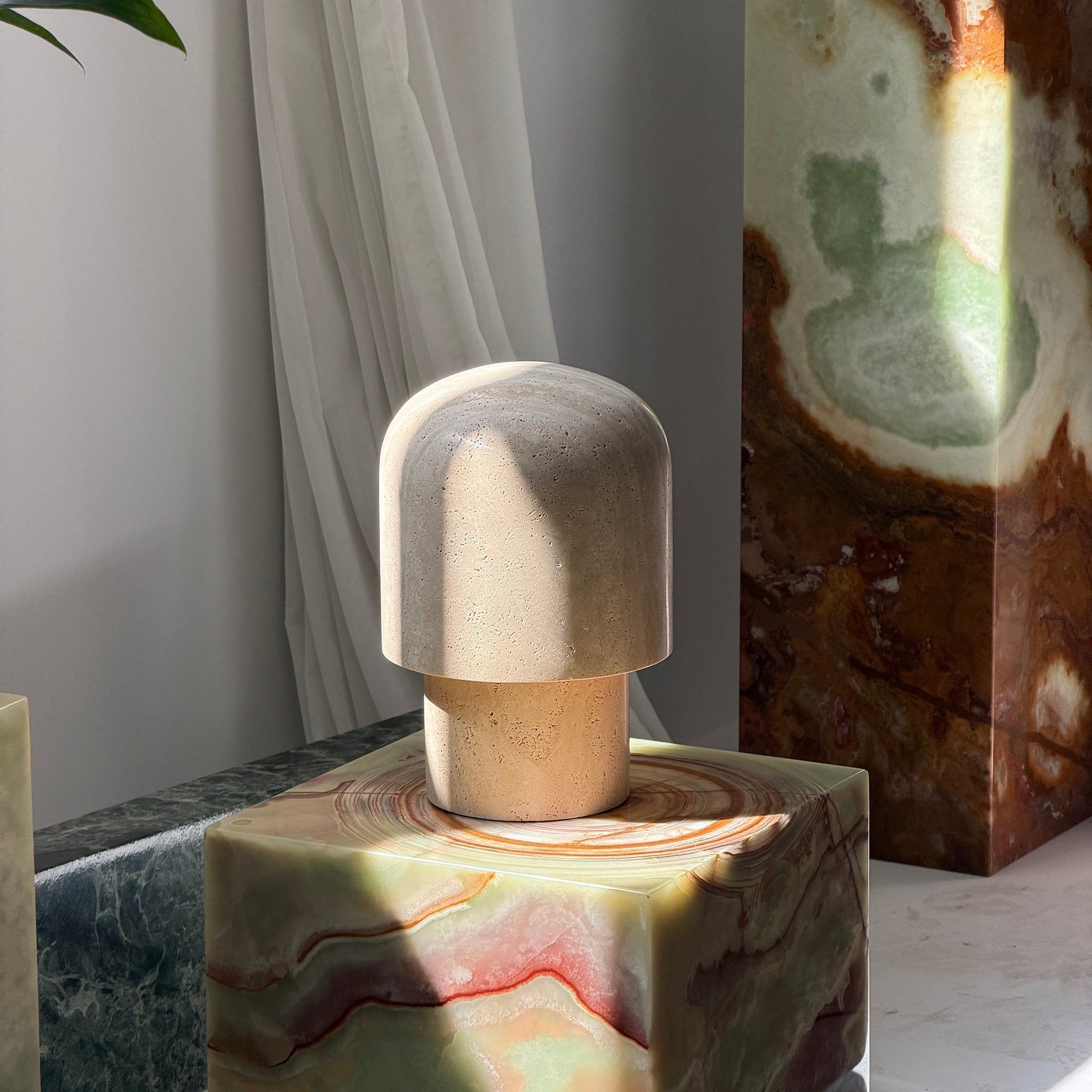 Kennett Travertine Table Lamp styled on a living room side table.