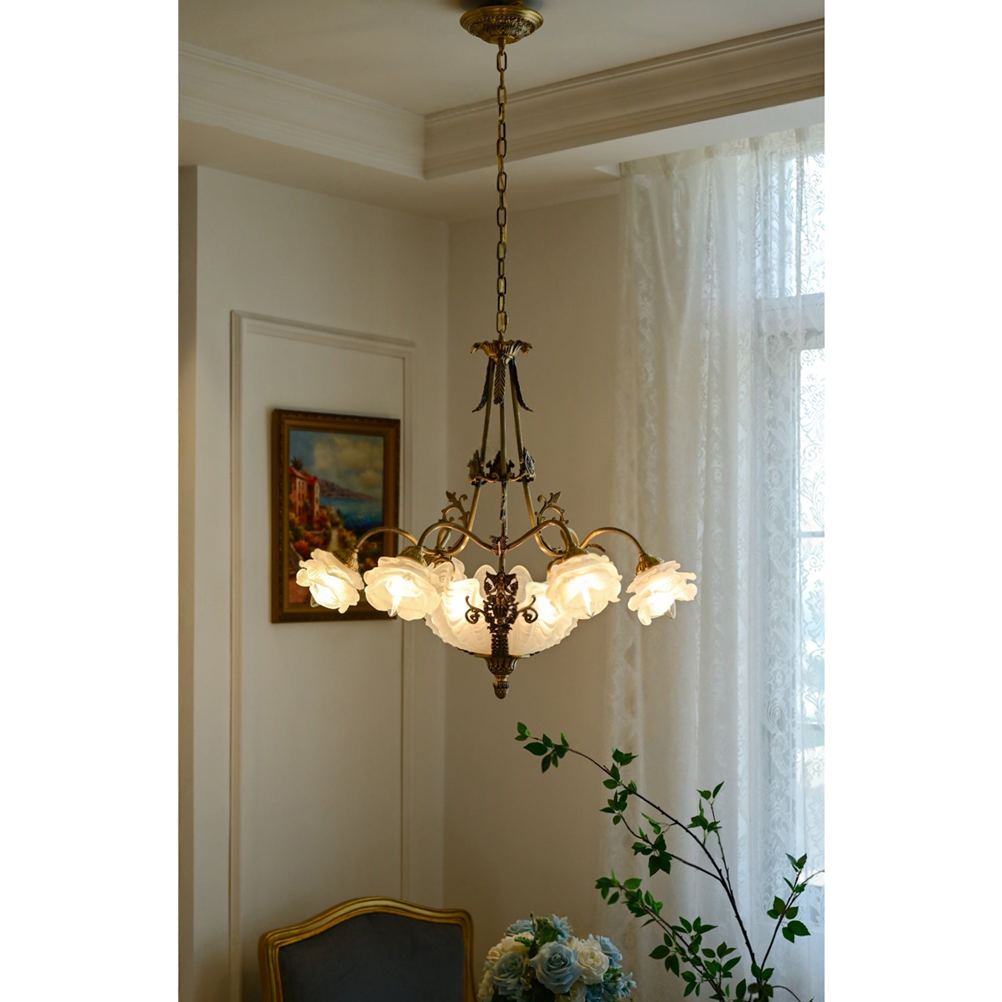 The chandelier illuminated, casting a soft, romantic glow in a dark room.