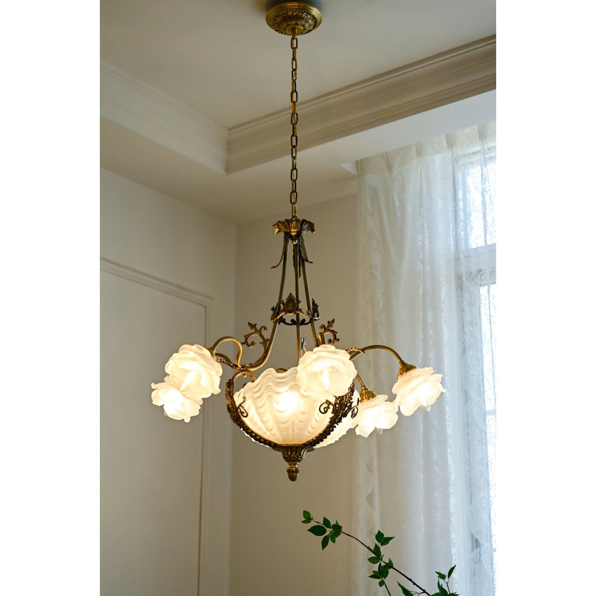Angled view of the antique bronze chandelier highlighting its brass body.