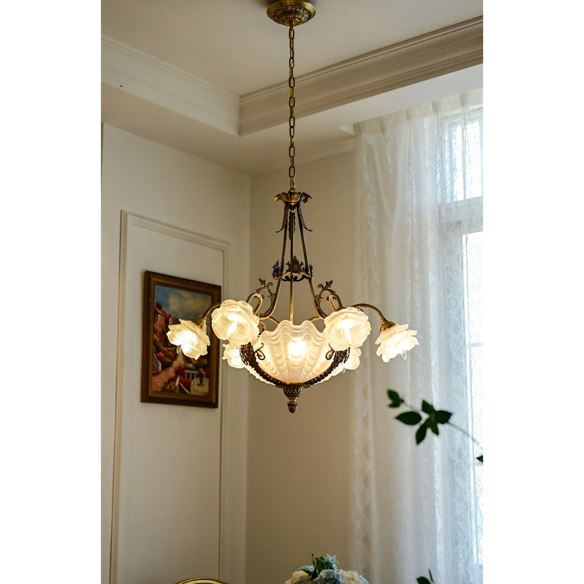 The grand chandelier hanging in a luxurious living room setting.