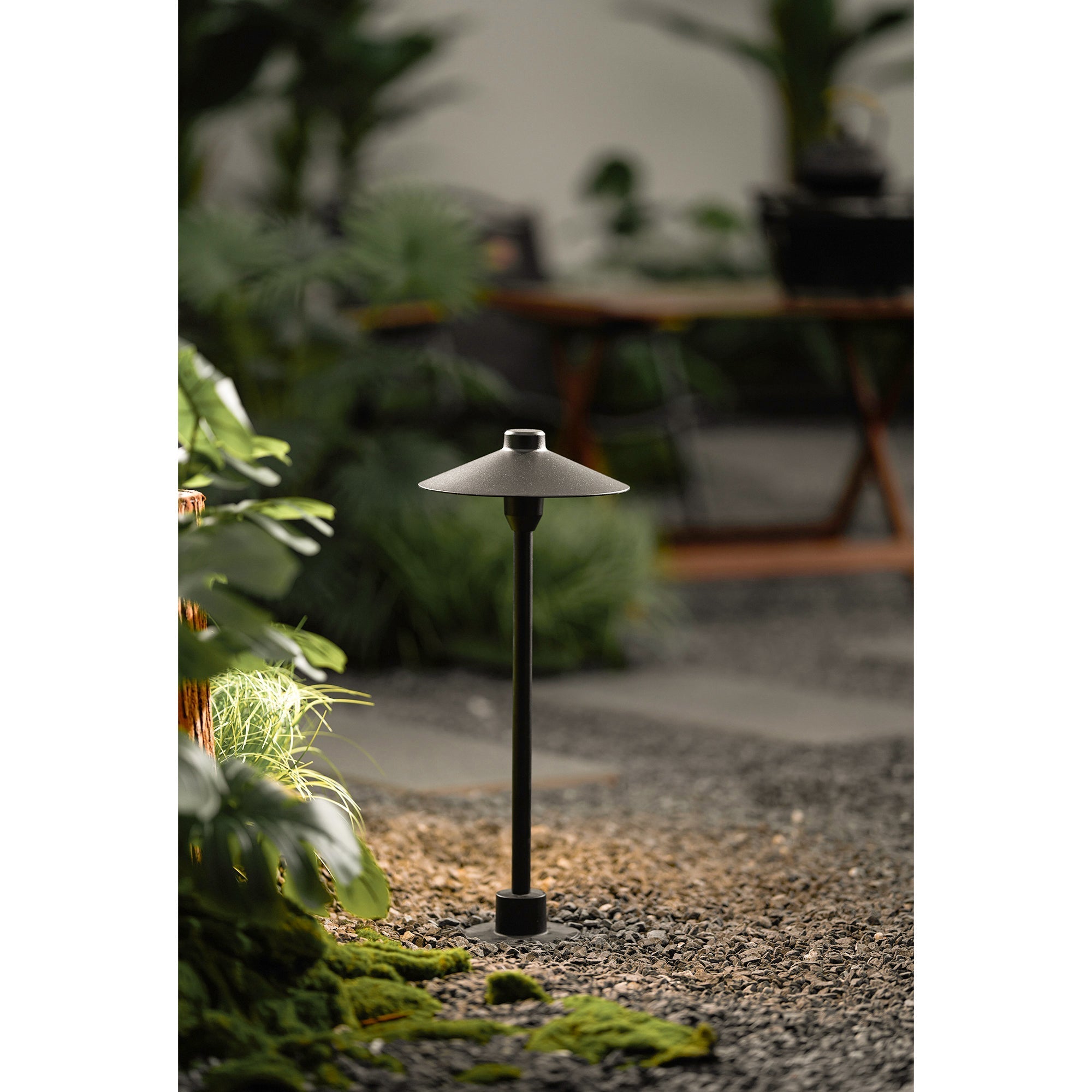 The black aluminum lamp against a light-colored background.