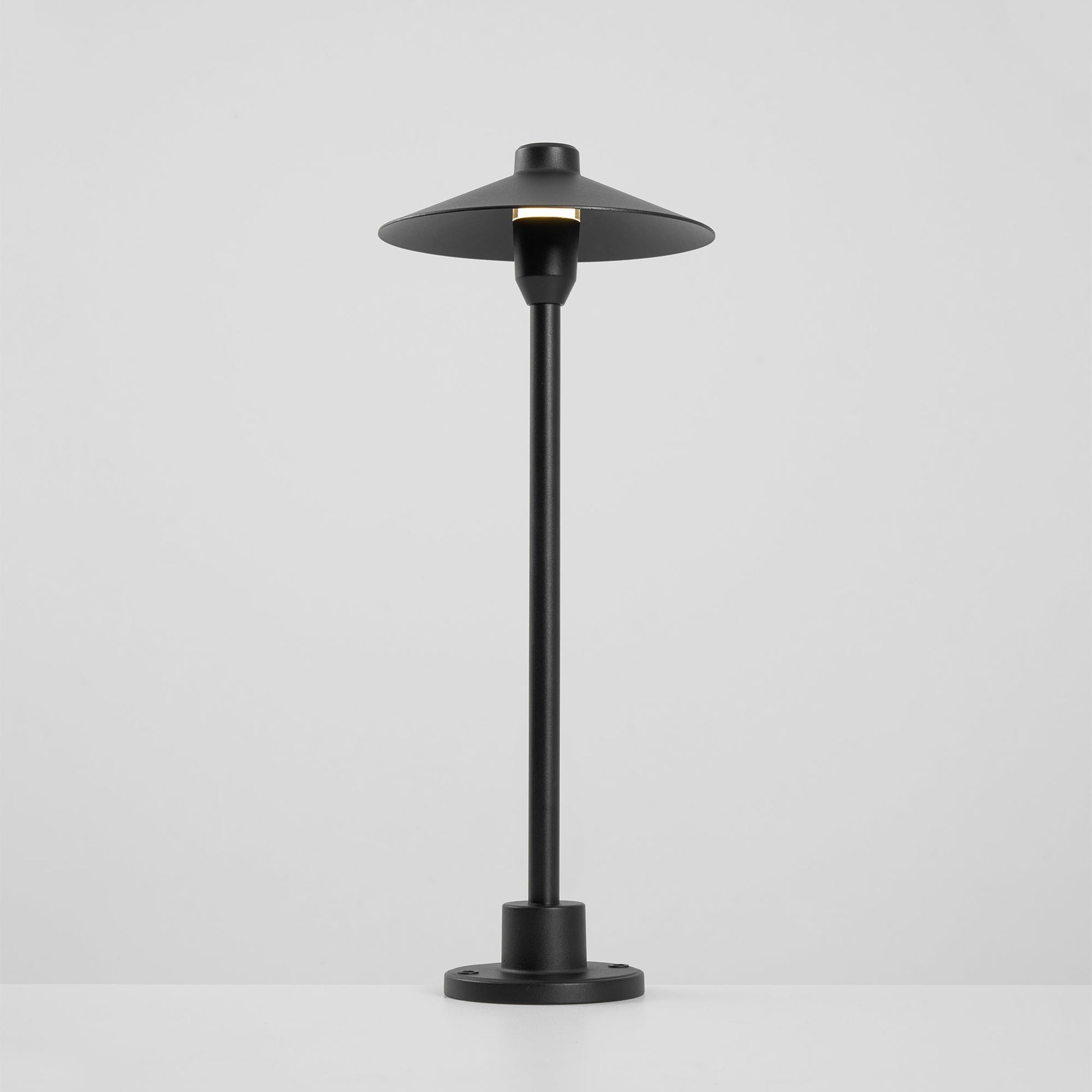 The lamp's cone shade and its light diffusion.