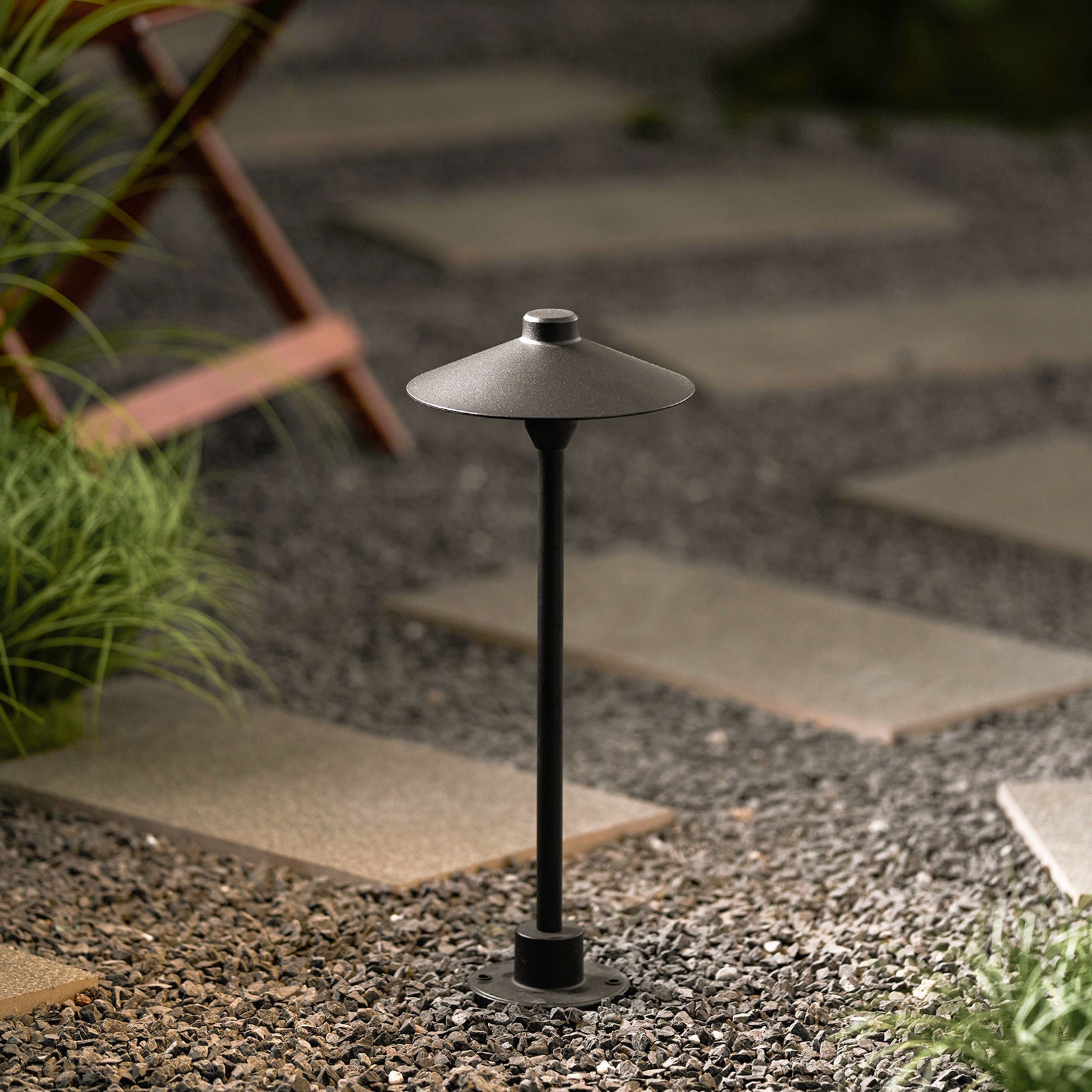 Kichler outdoor lamp shown in a garden setting.
