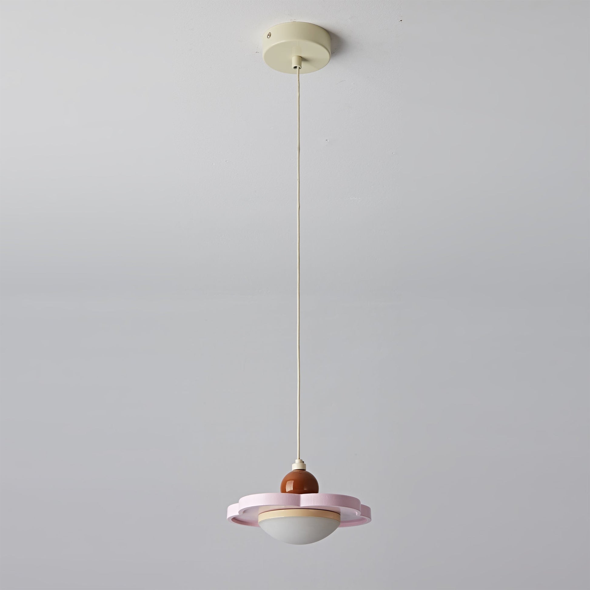 Angled shot of the cream pendant light.