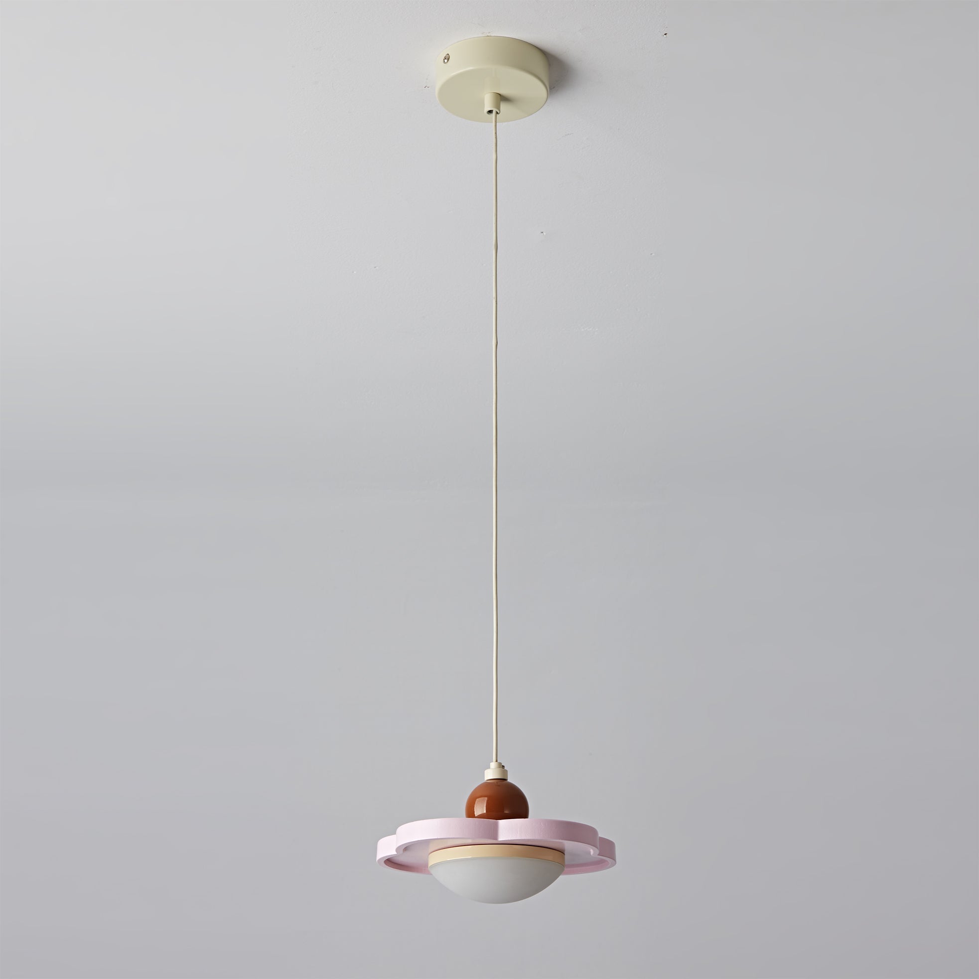 Angled shot of the cream pendant light.
