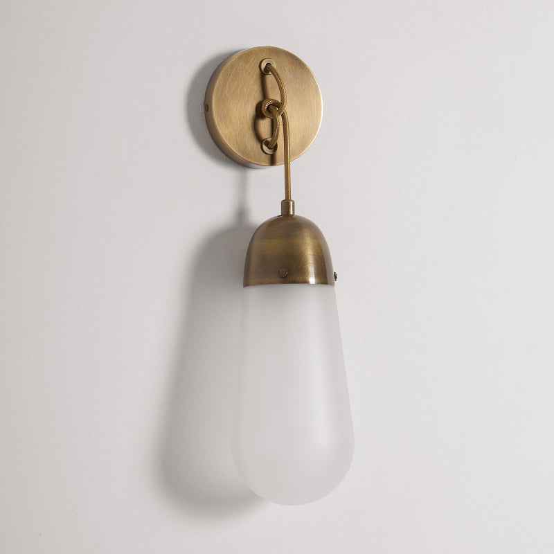 Detail of the junction between the glass shade and brass arm.