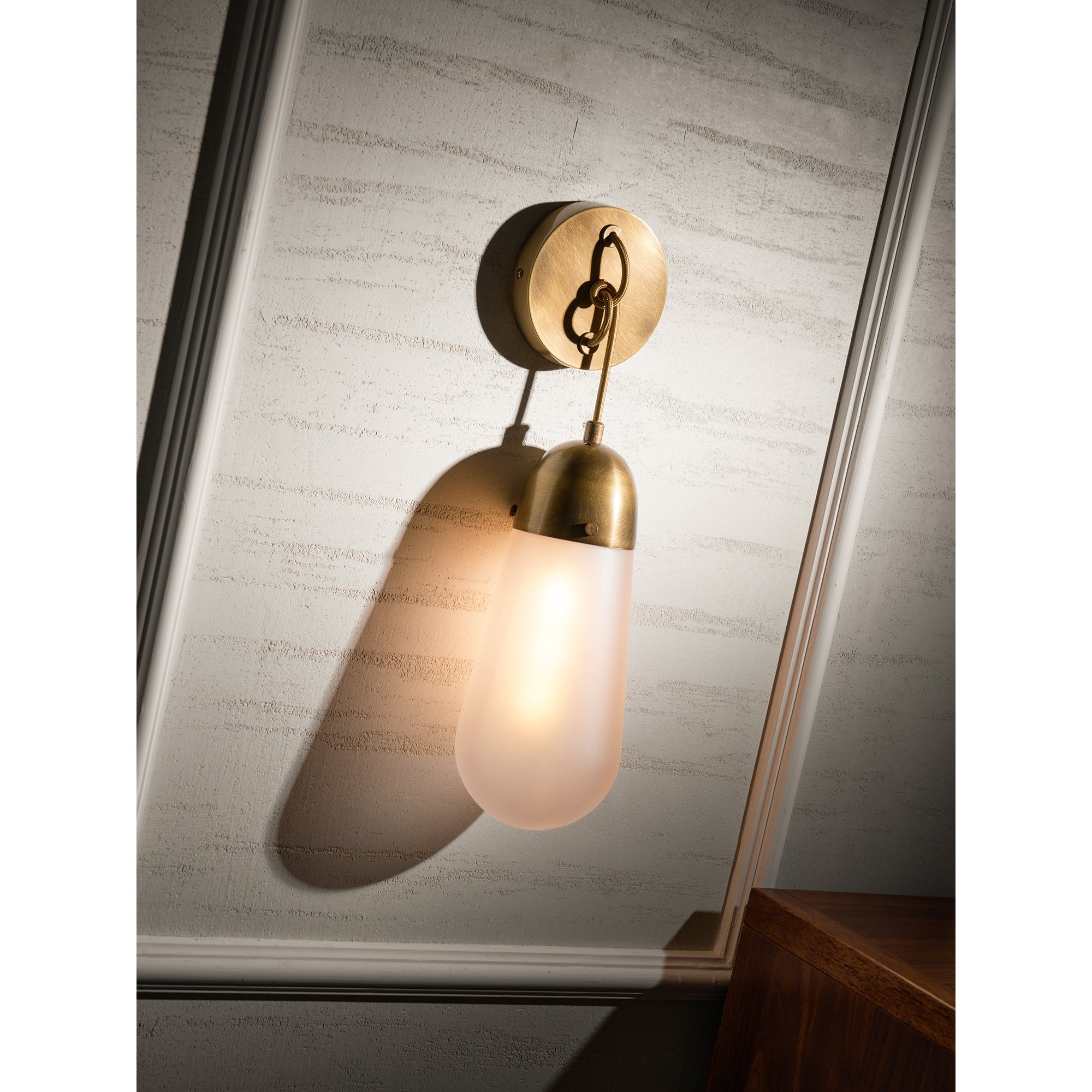 Unlit Lariat Wall Lamp in black, highlighting its sleek lines.