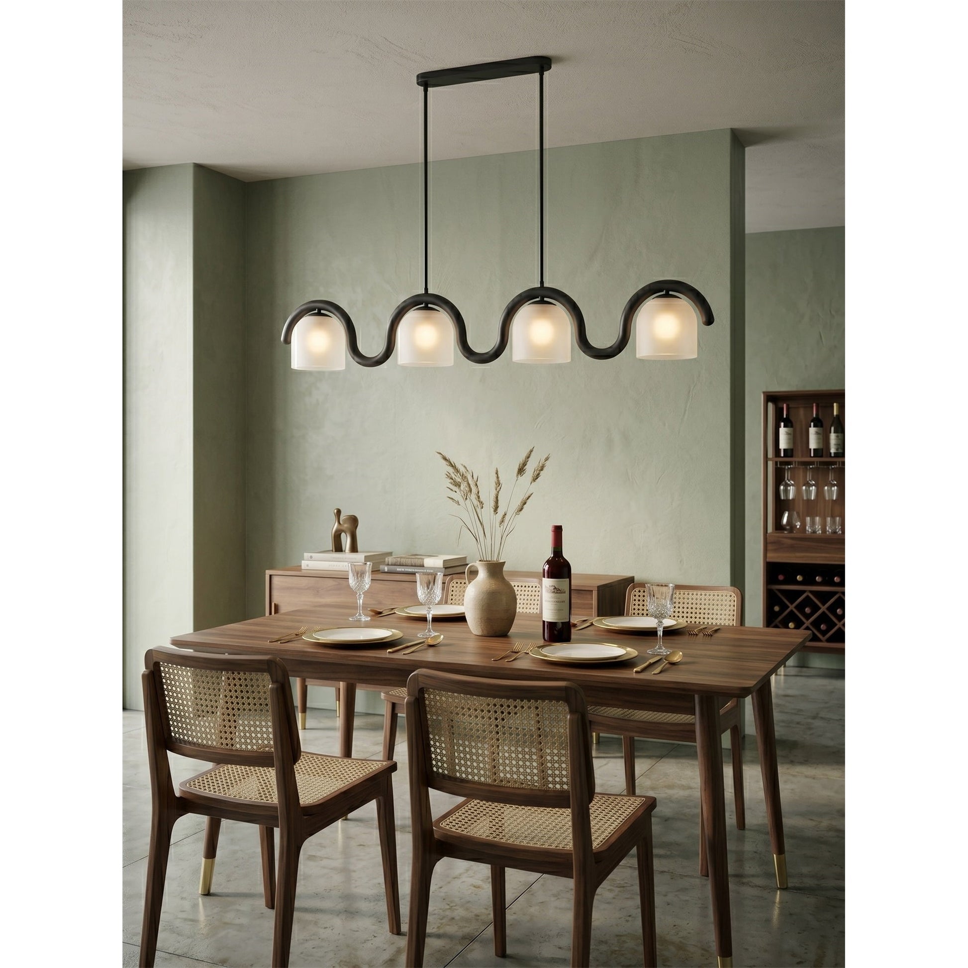 The Lenox linear chandelier installed over a long wooden dining table.