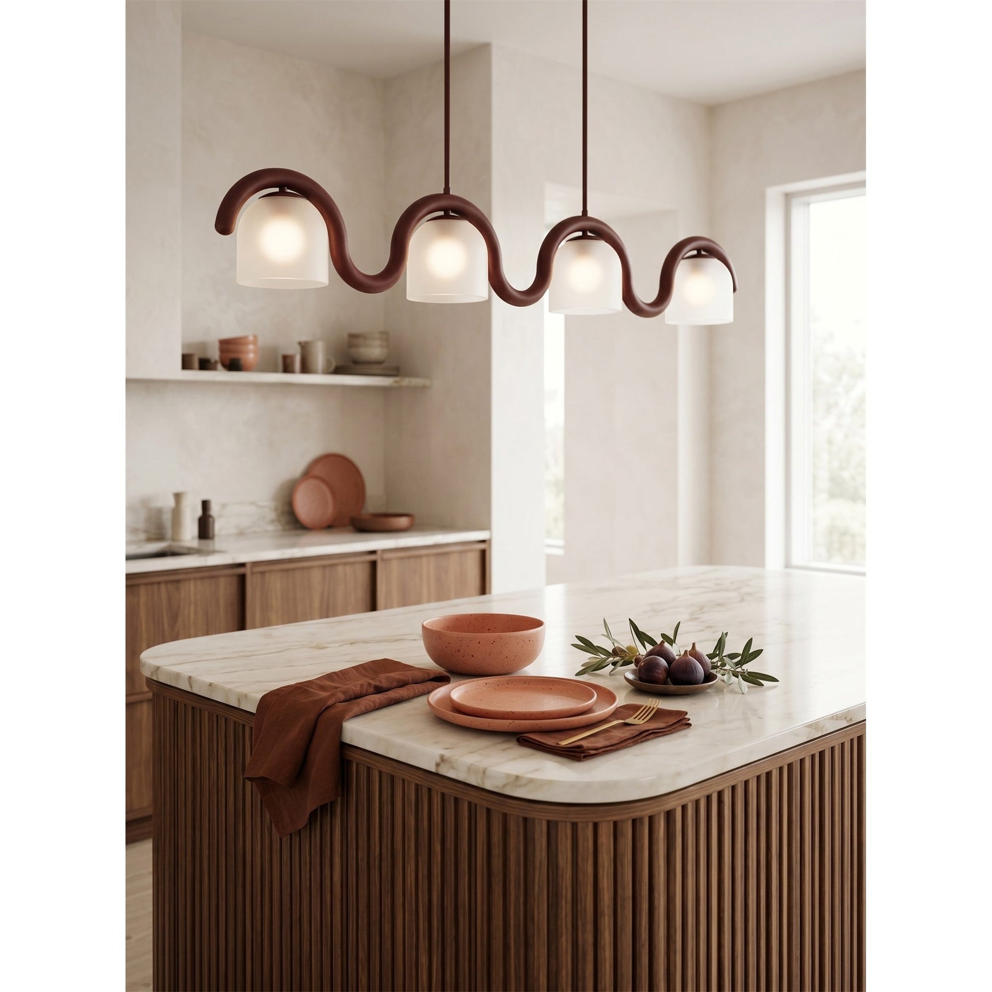 The Lenox linear chandelier illuminating a modern kitchen island with marble countertop.