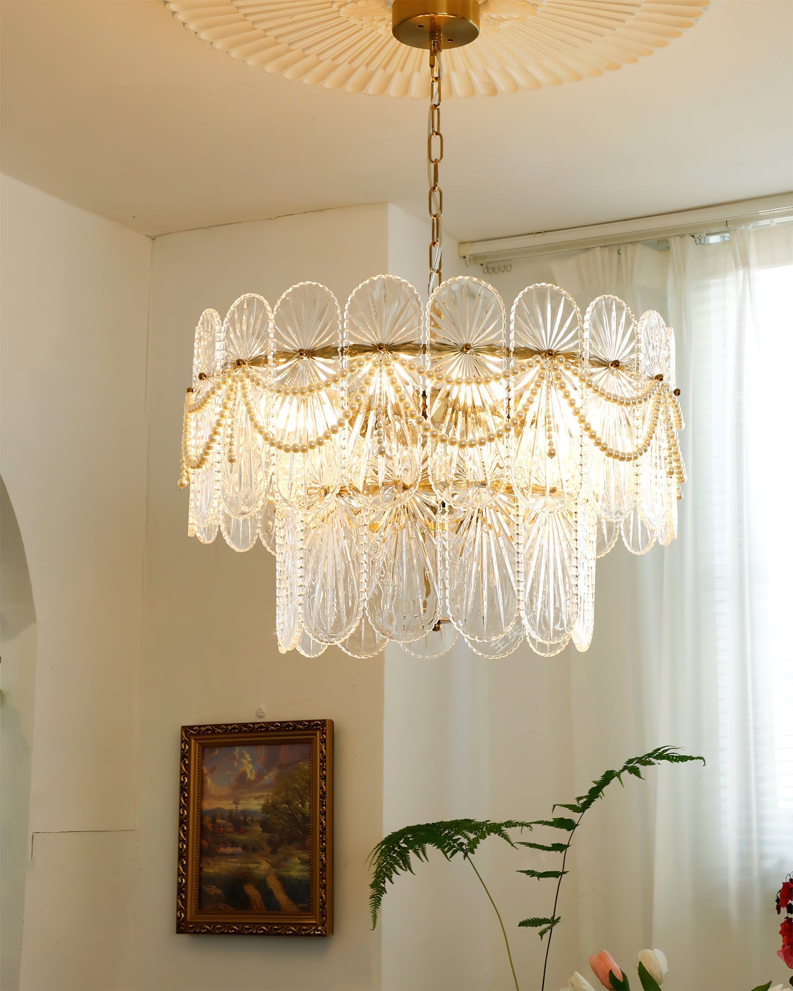 The 6-light version of the Leon Chandelier hanging in a living room.