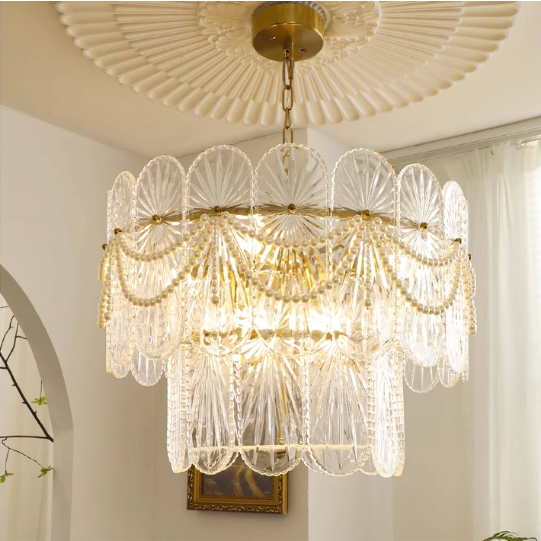 The Leon Chandelier lit up, casting a warm glow in a dining room setting.