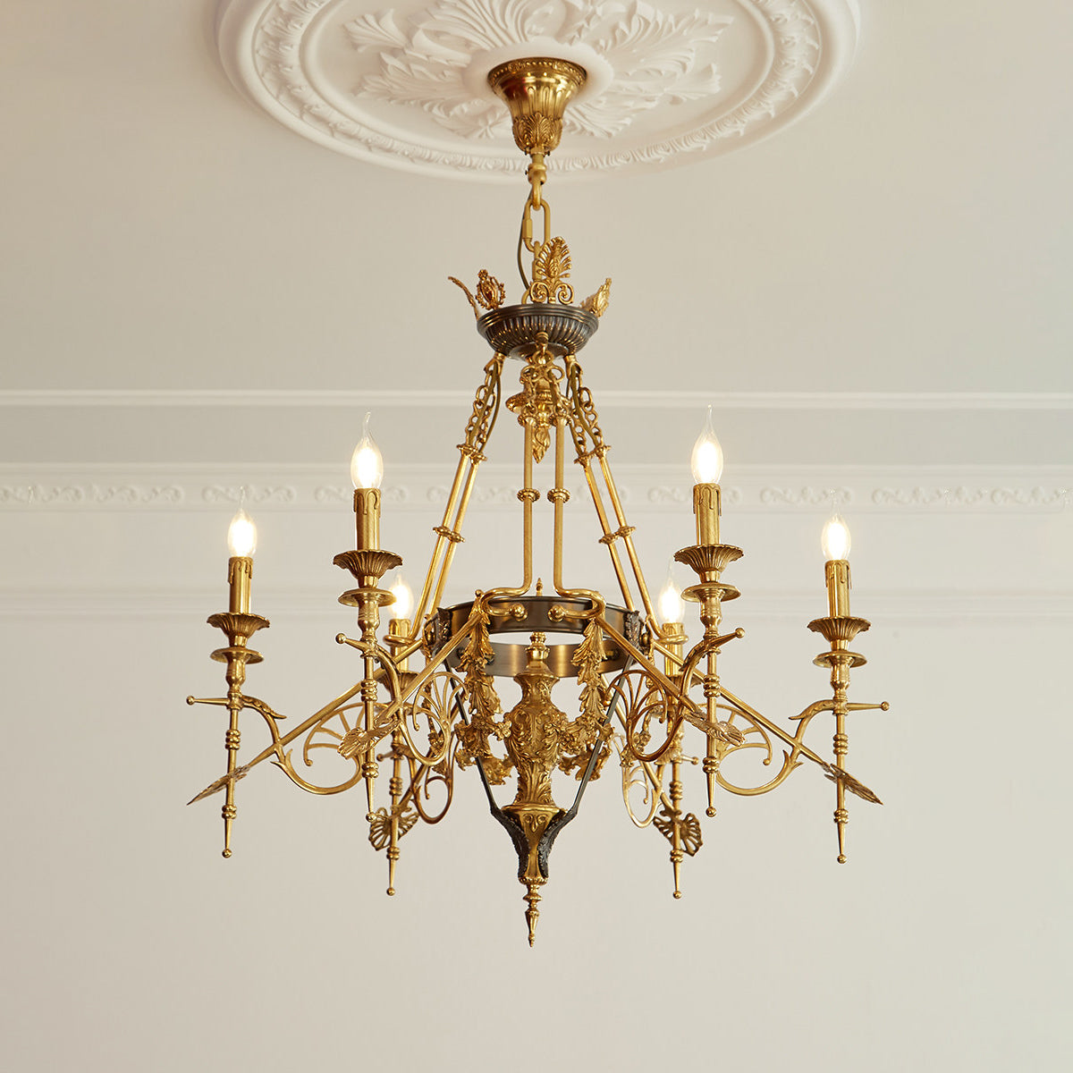 The chandelier with lights on, casting a warm glow.