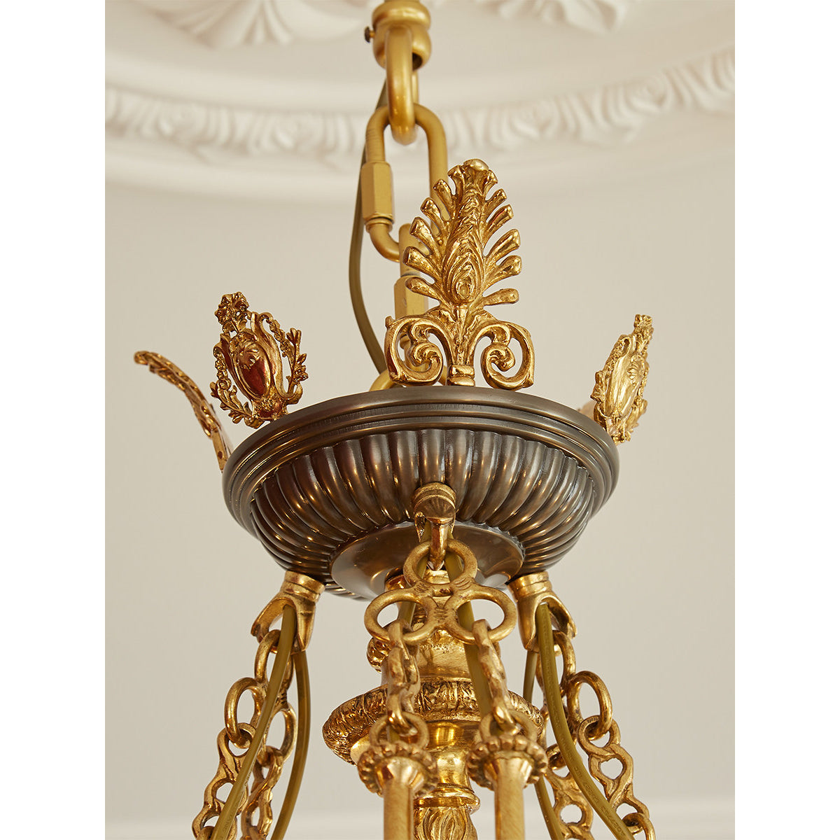 Detail of the bright-cut gilt finish on the brass arms.