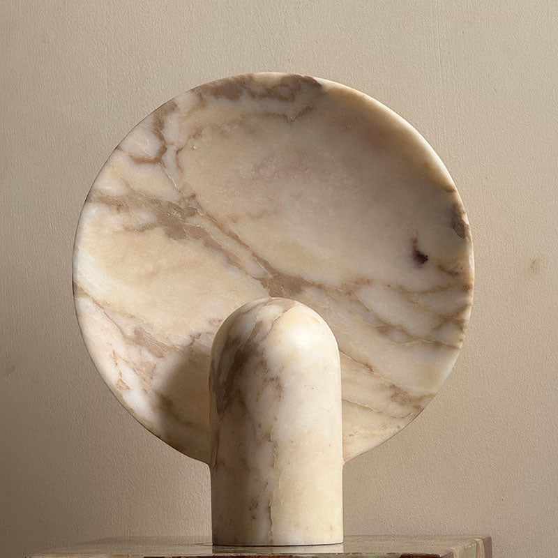Cyan onyx lamp on a marble countertop.