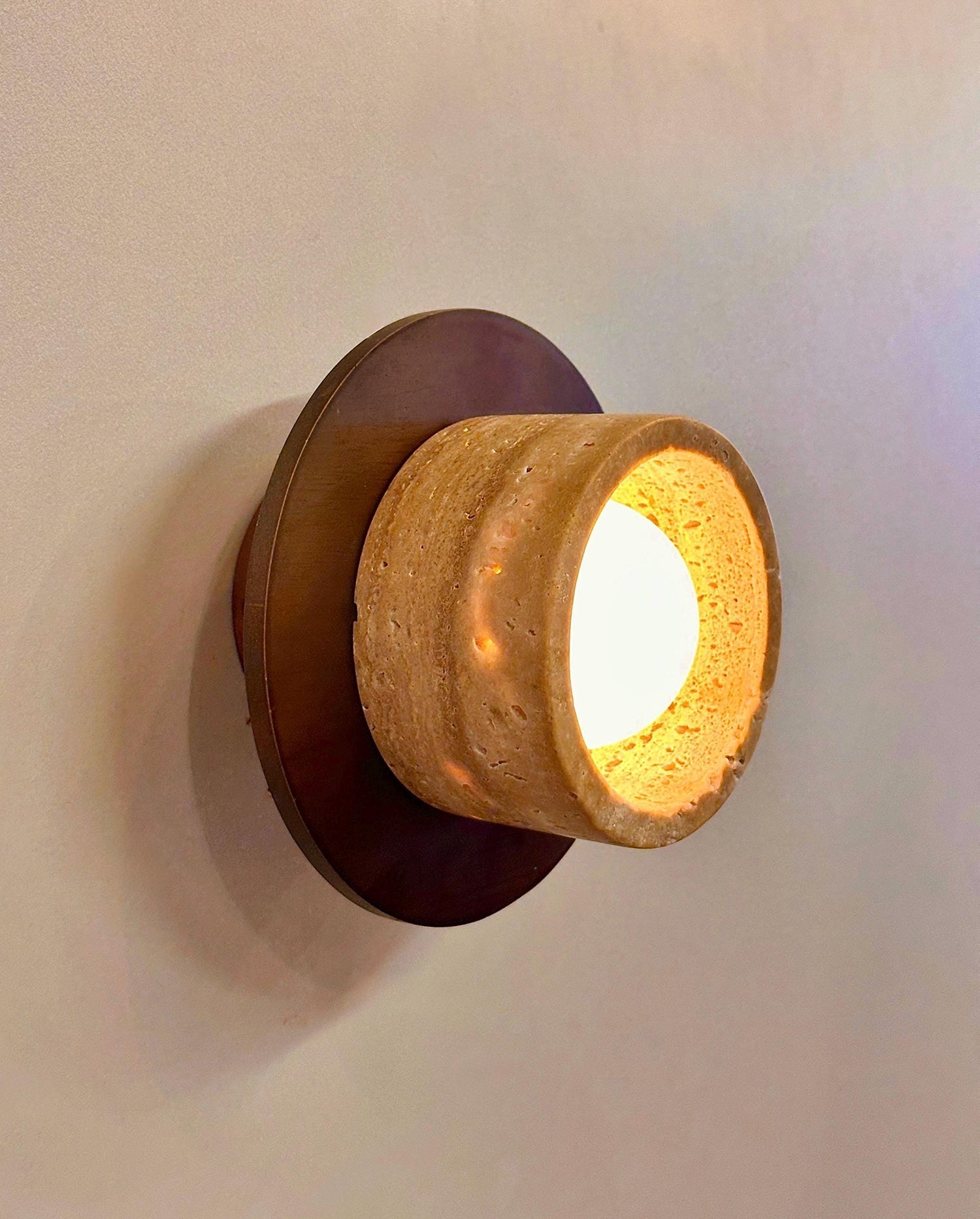 Side view of the Logatec Traverine Wall Lamp, highlighting its profile.