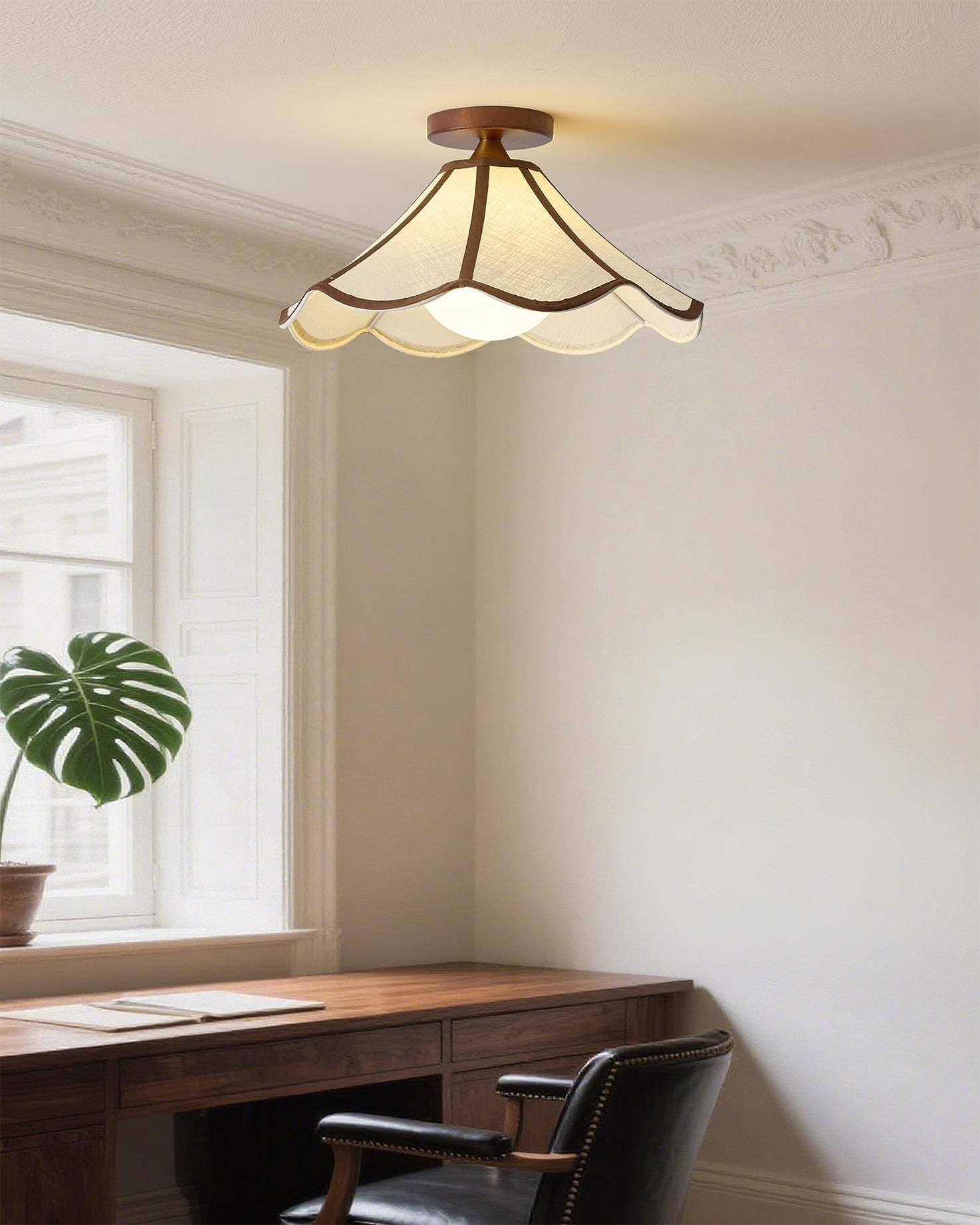 Close-up of the scalloped fabric shade and wood detail.