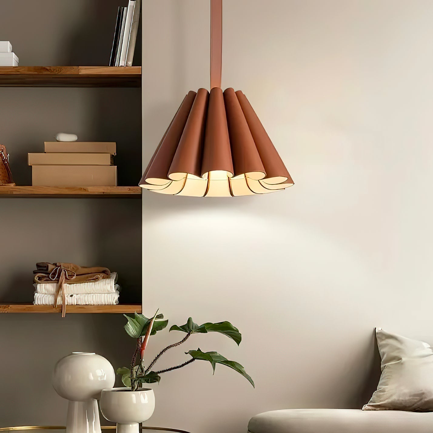 Close-up view of the Lora Pendant Lamp's brown leather shade and iron details.