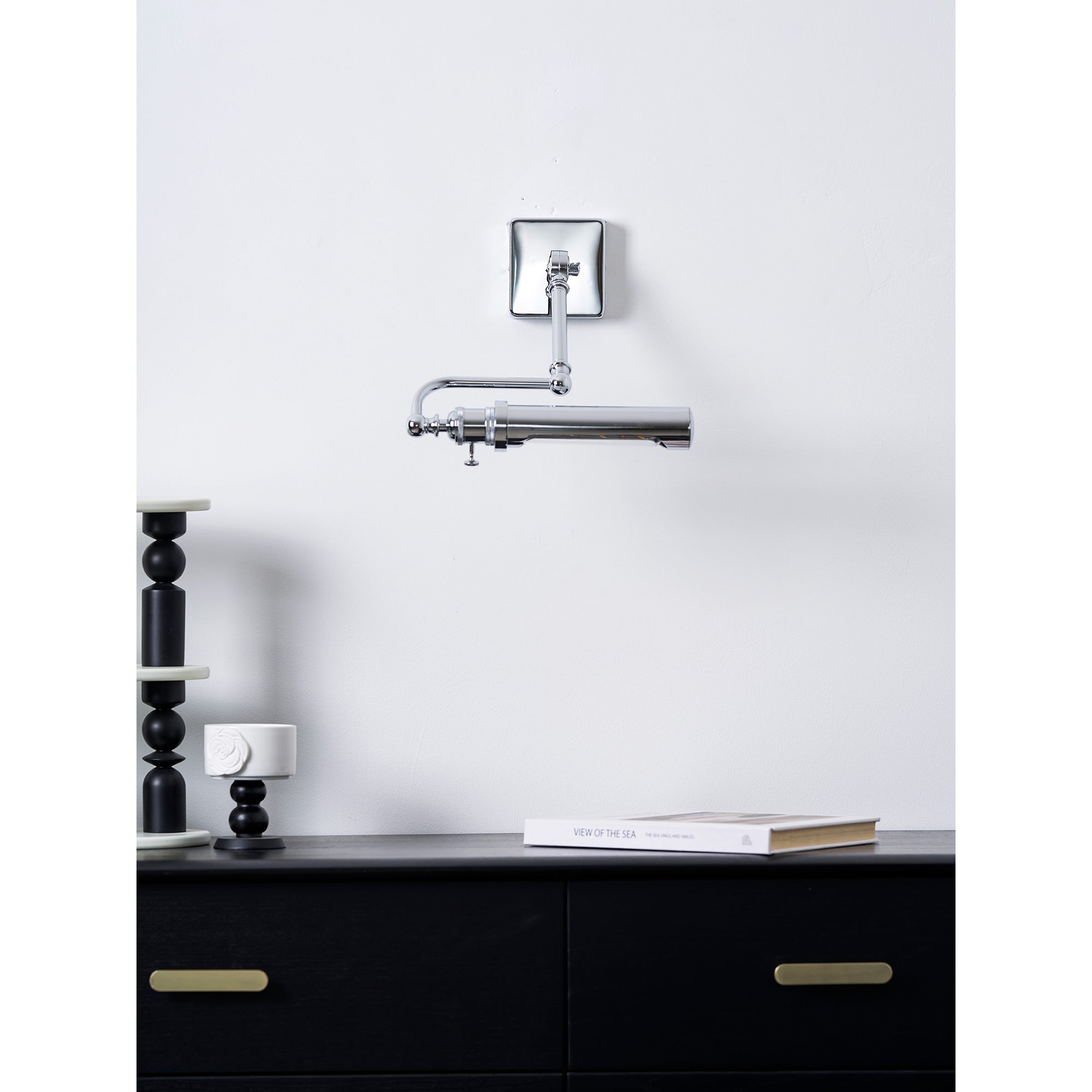 Lifestyle image of the Luca Wall Lamp over a reading nook.