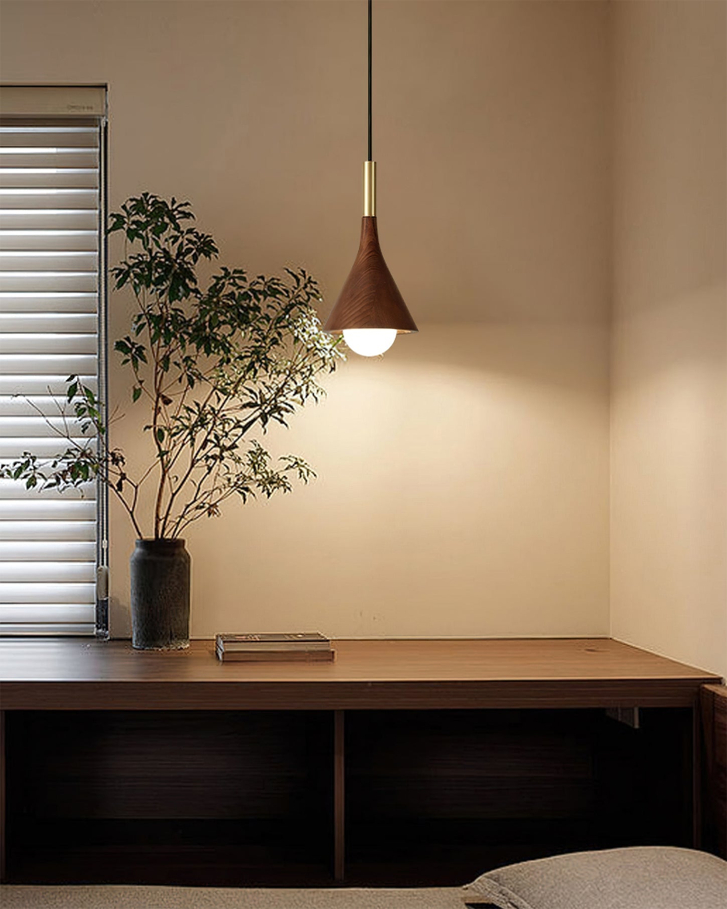 Lucian Pendant Lamp hanging over a modern dining table.