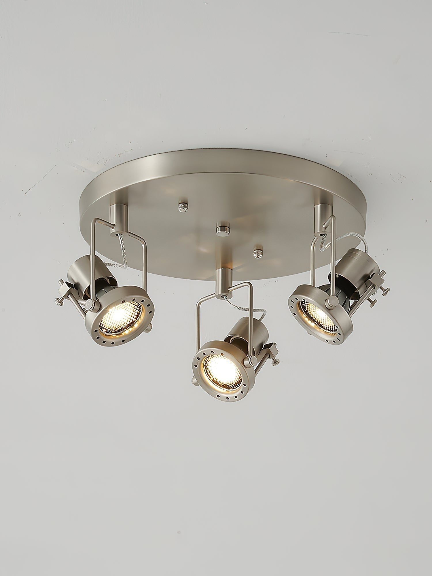 The industrial ceiling lamp providing illumination over a kitchen counter.