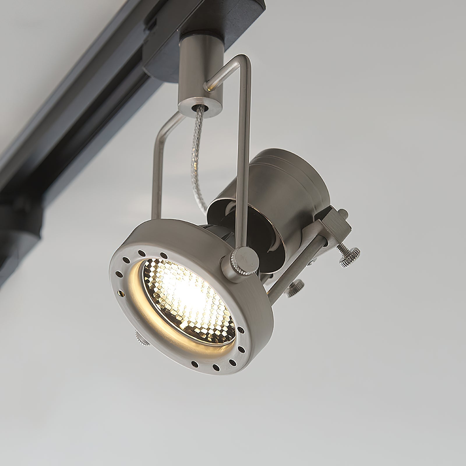 Two-head nickel industrial track light system on a 1-meter track.