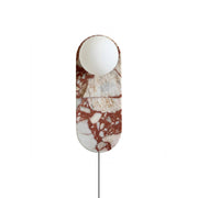 Front view of the Lucie Red Plug-in Wall Lamp showcasing its marble base and glass shade.