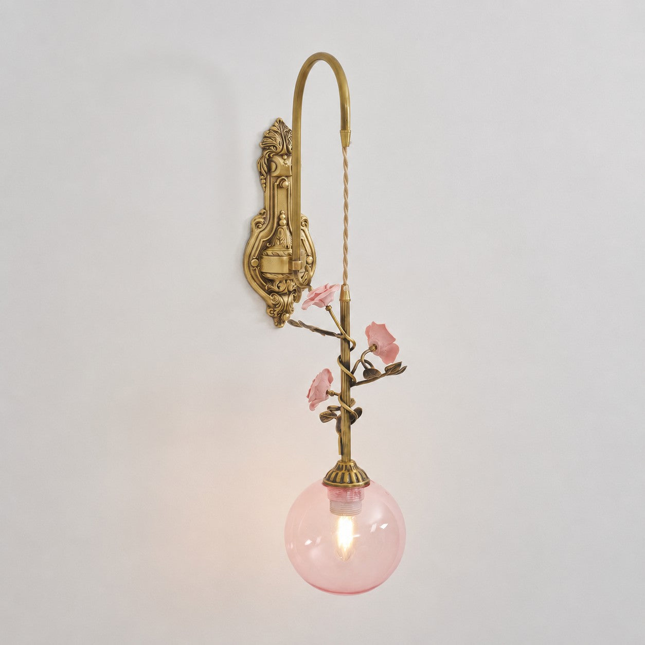 The white glass rose sconce, unlit, displaying its clean look.