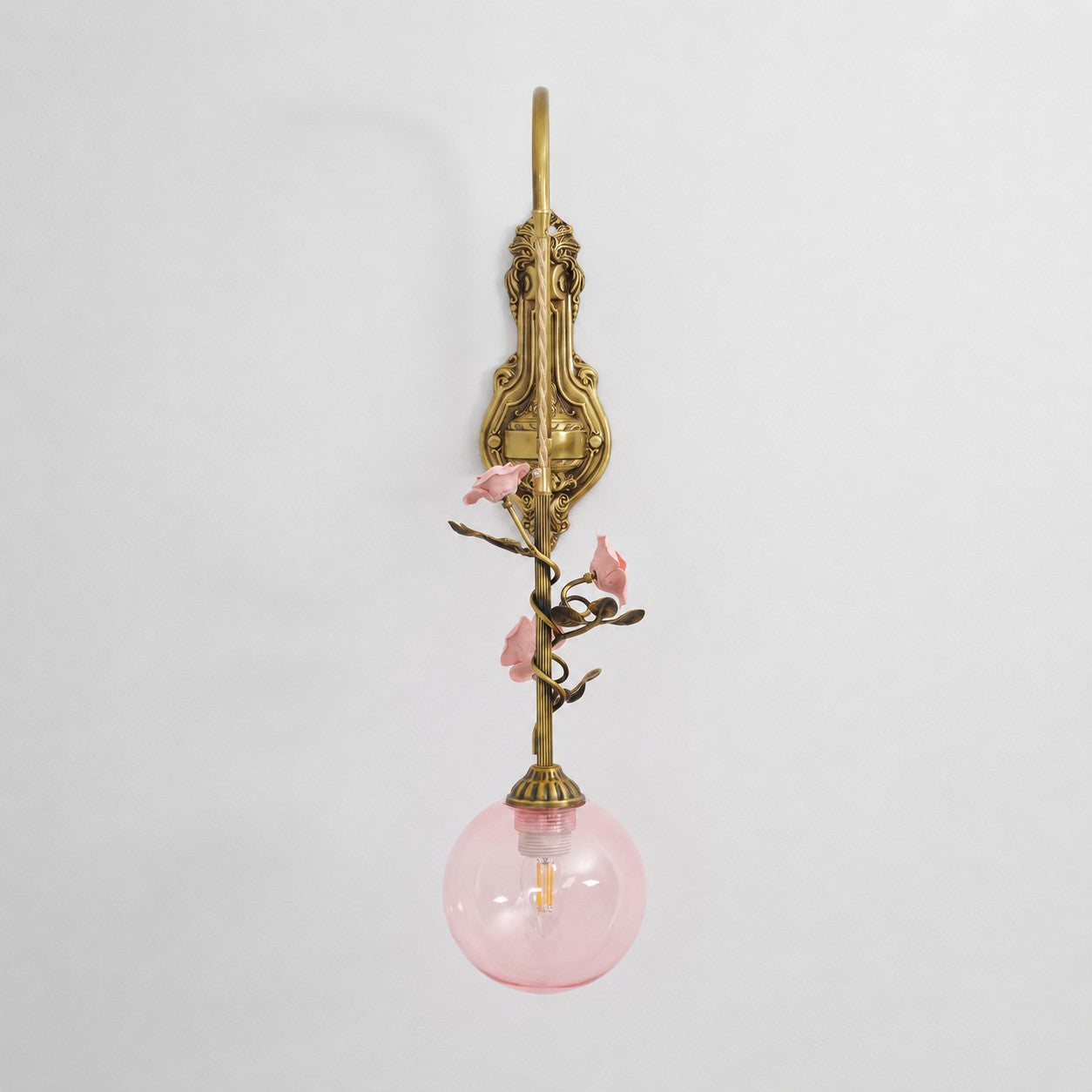 Detail shot focusing on the vine-like iron structure and antique brass finish.