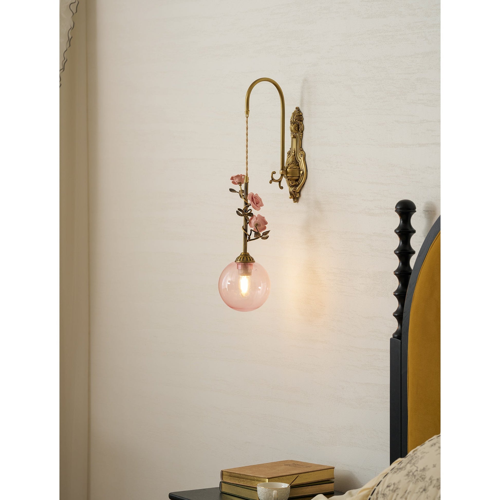 Angled view of the Evelyn sconce, showing the antique brass iron body.