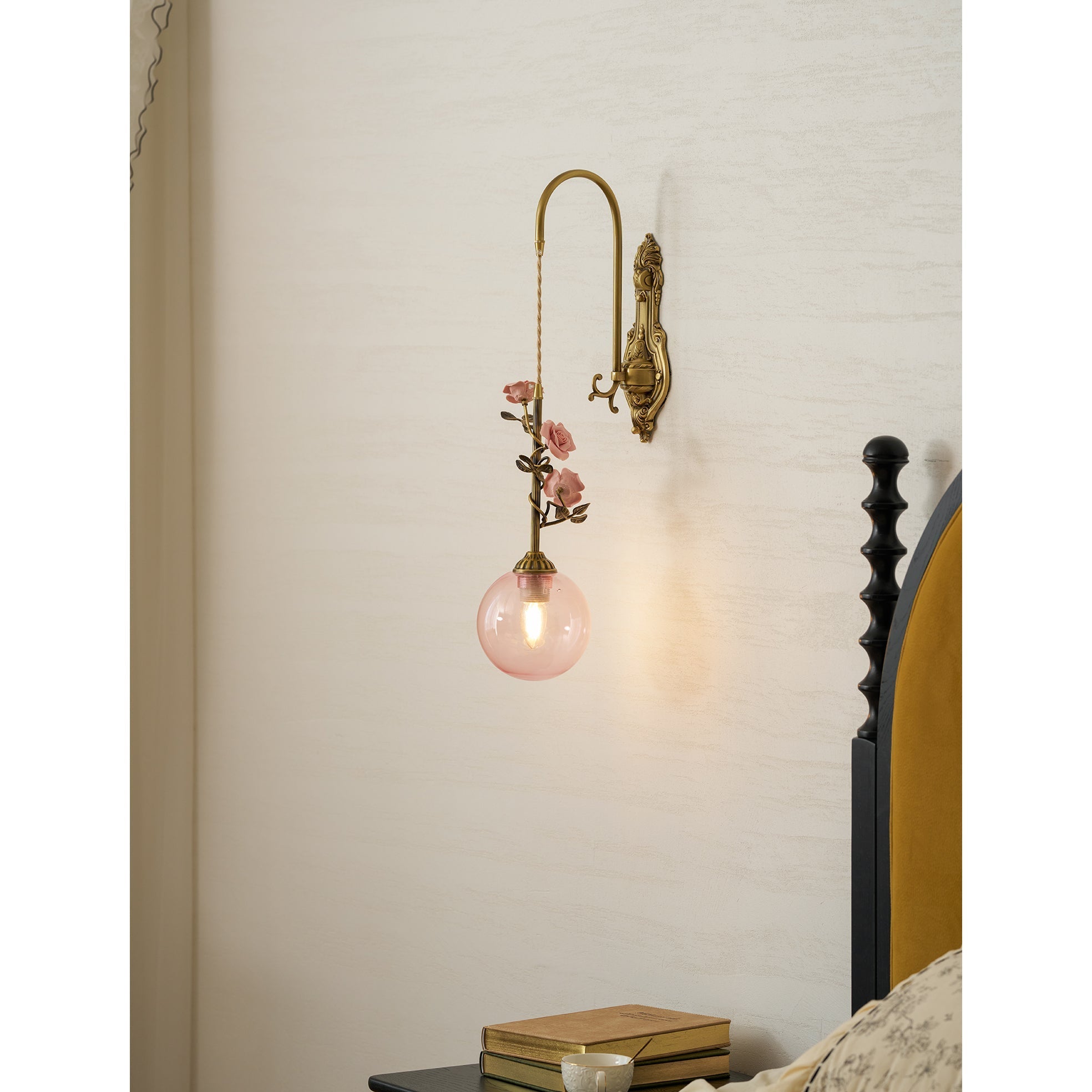 Angled view of the Evelyn sconce, showing the antique brass iron body.