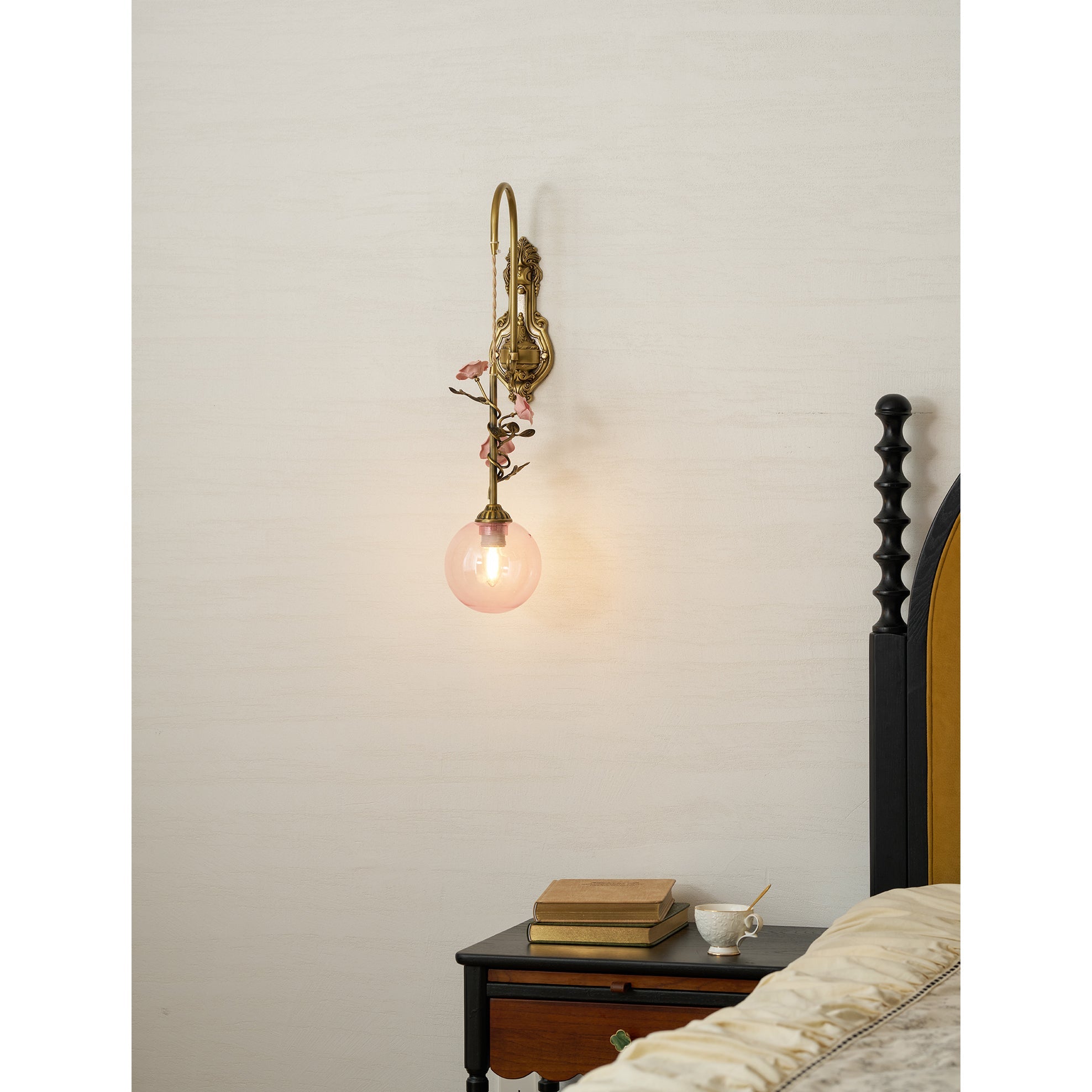 The Evelyn wall sconce mounted in a chic living room setting.