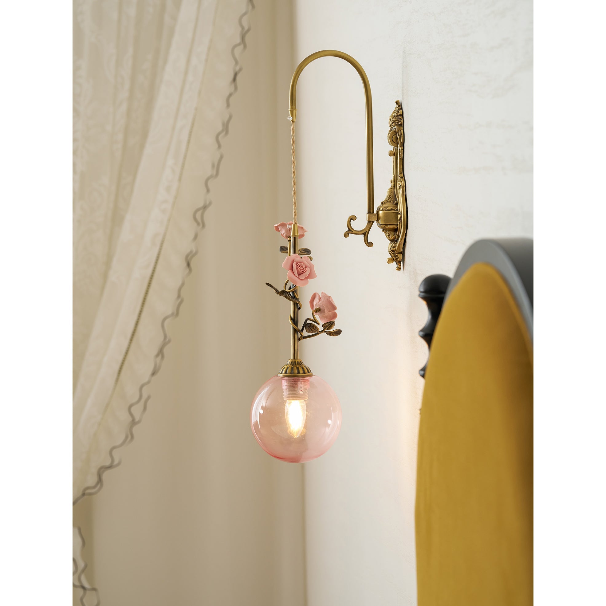 Side profile of the pink glass rose wall sconce.