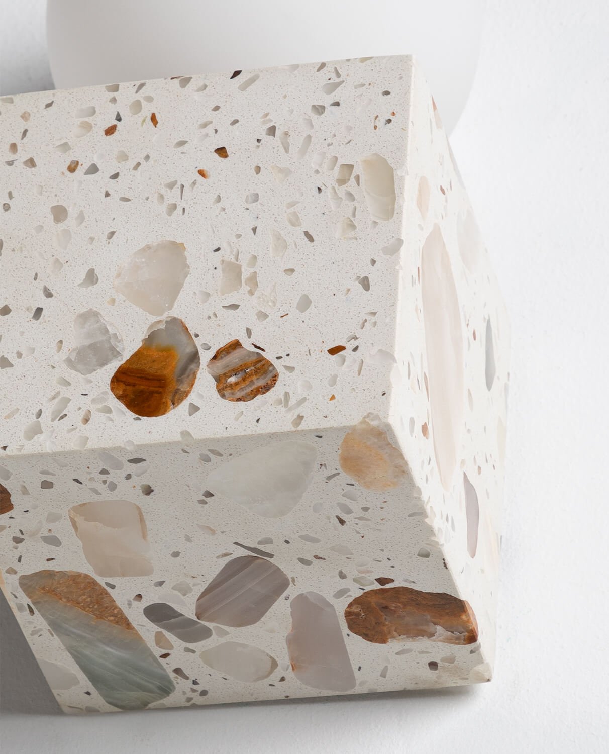 Top-down view of the terrazzo cube sconce showing the light source opening.
