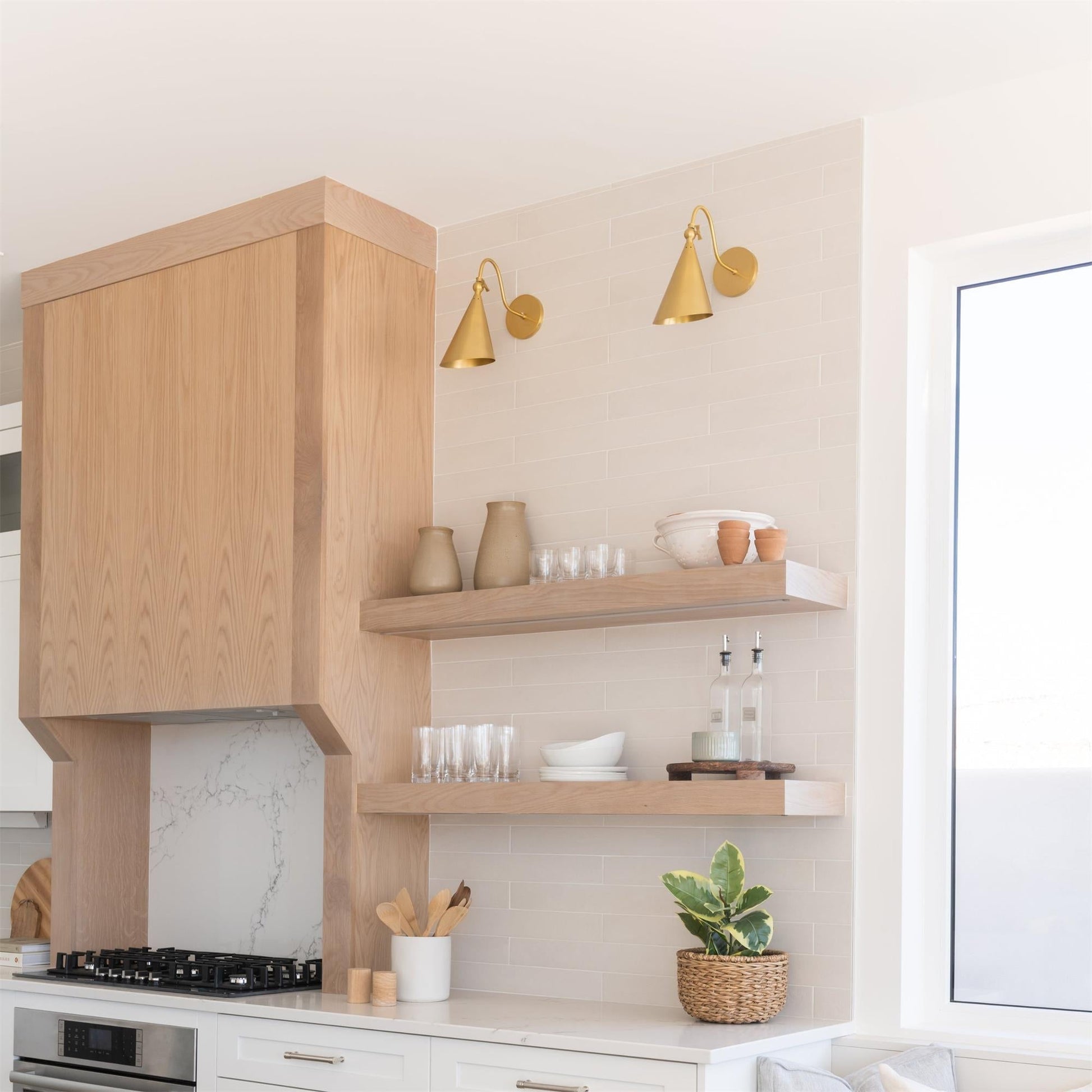 The adjustable head of the Trumpet Wall Lamp tilted downwards.