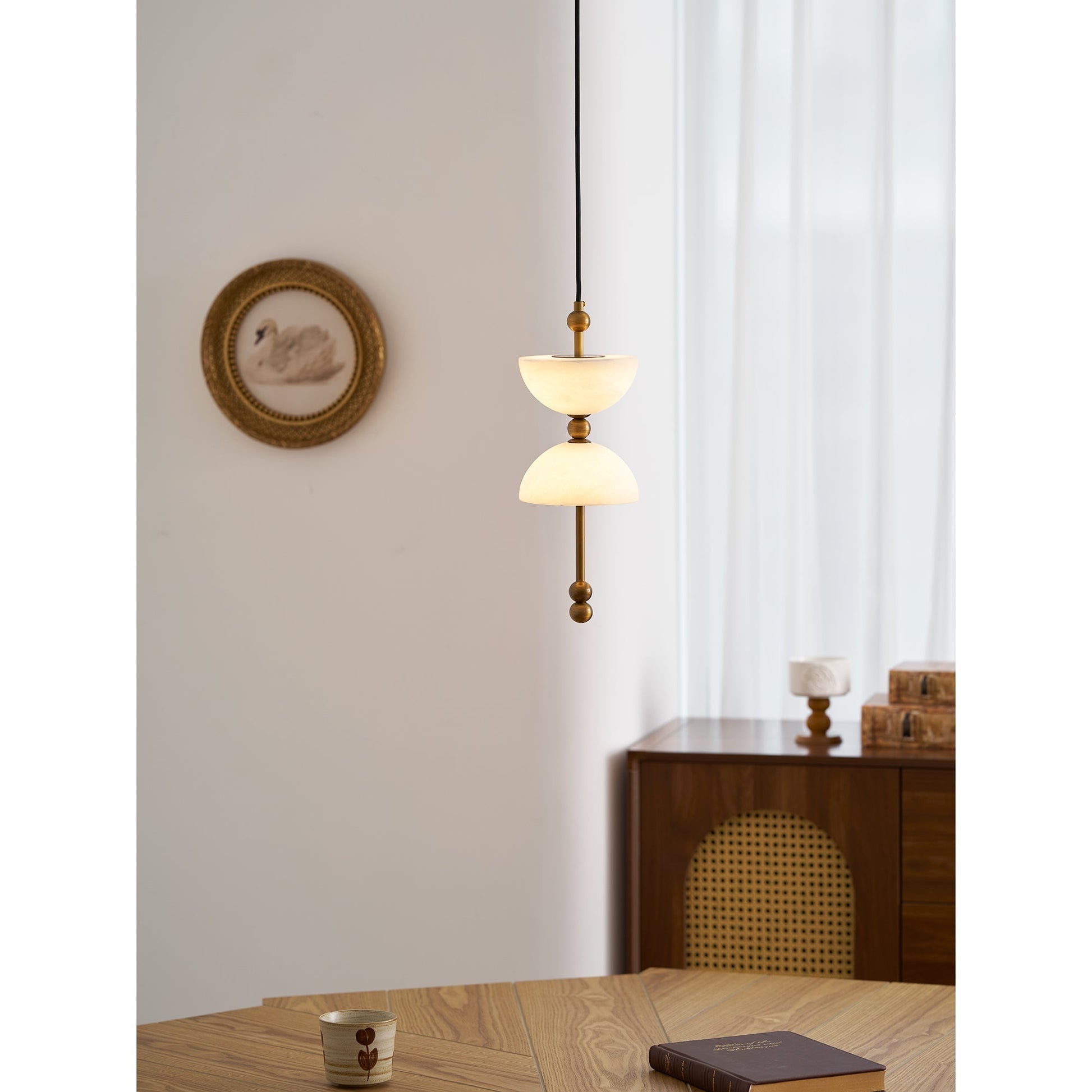 The antique brass finish Lyra pendant lamp, unlit.